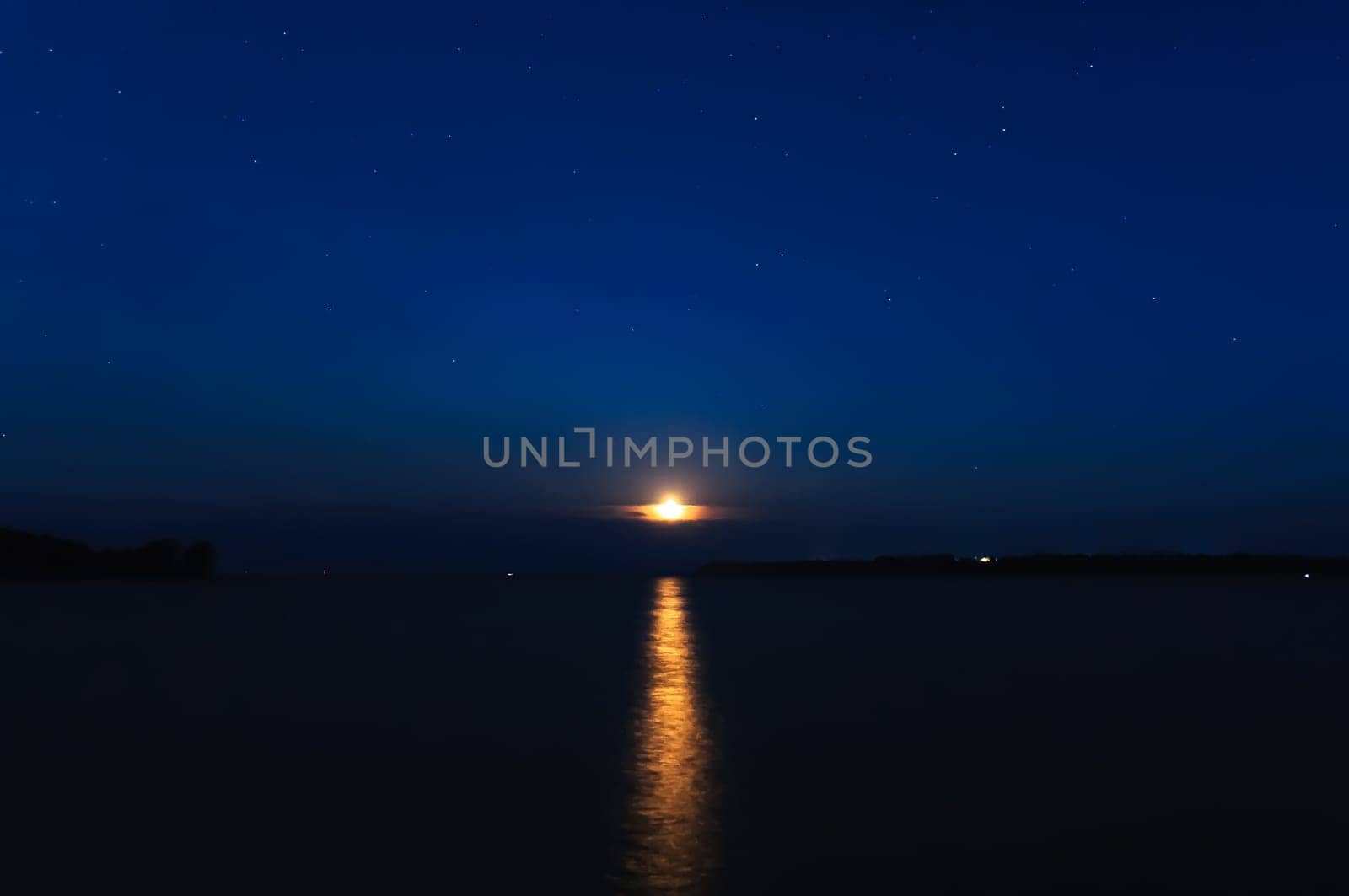 night landscape with moon and stars on a background of sky and river with reflection