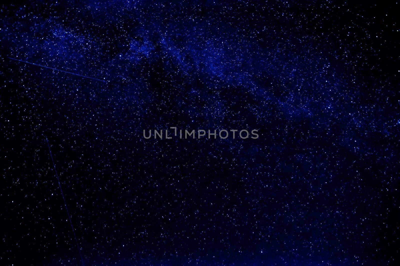 dark blue sky with falling stars and the milky way