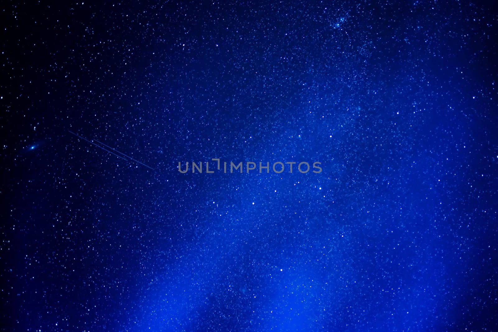 abstract blue background of stars in the night sky with the milky way