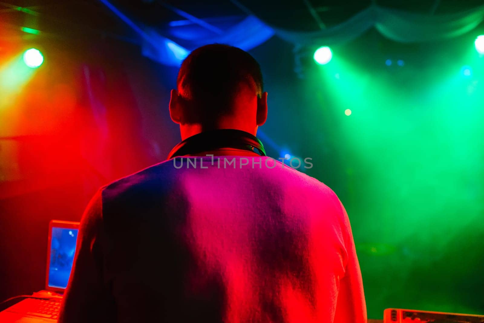 DJ in a nightclub mixes music for a party