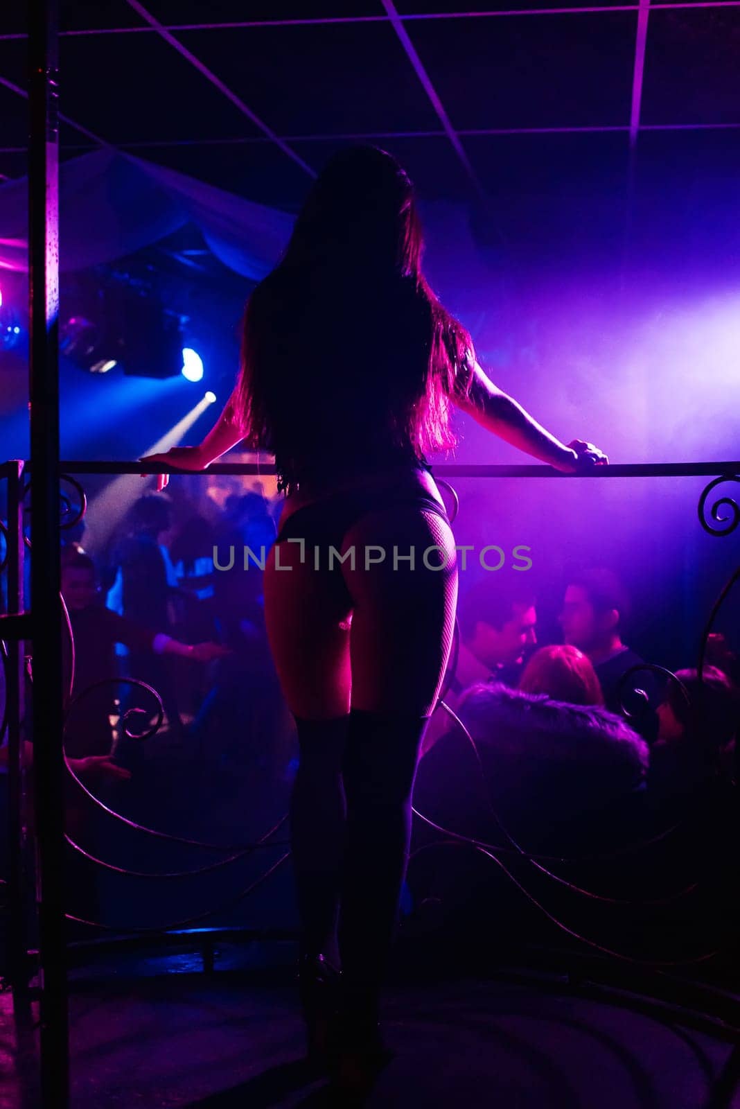 silhouette of a go-go dancer girl on stage in a nightclub