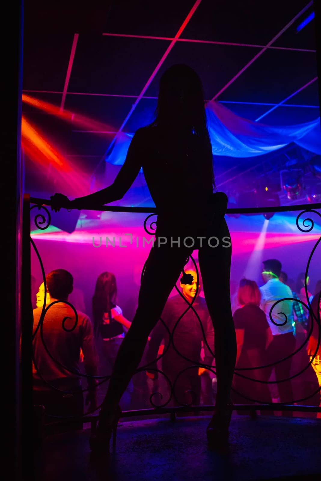 silhouette of a go-go dancer girl on stage in a nightclub
