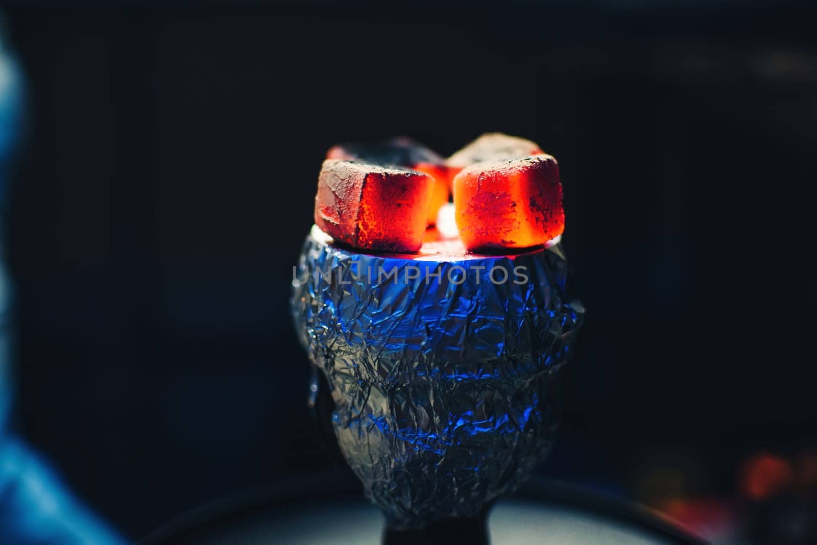 coals of the Shisha on the foil on the bowl with tobacco Smoking and red hot