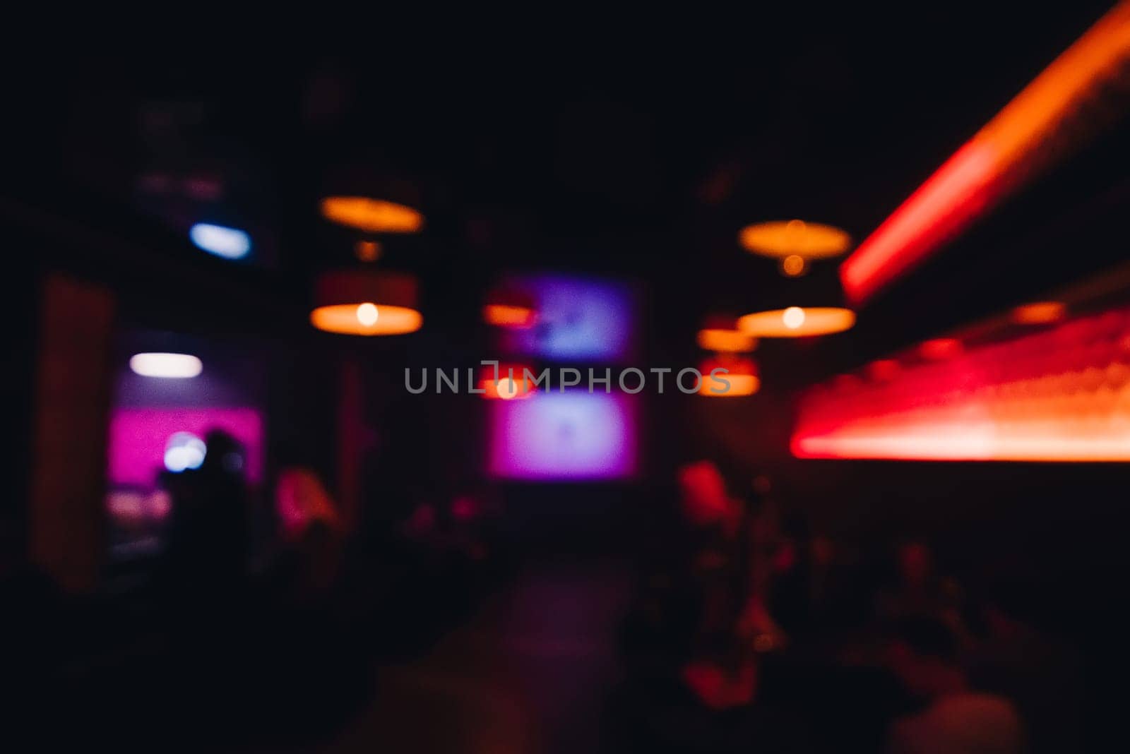 interior night restaurant with the rest blurred and out of focus by people and color the side from the blur