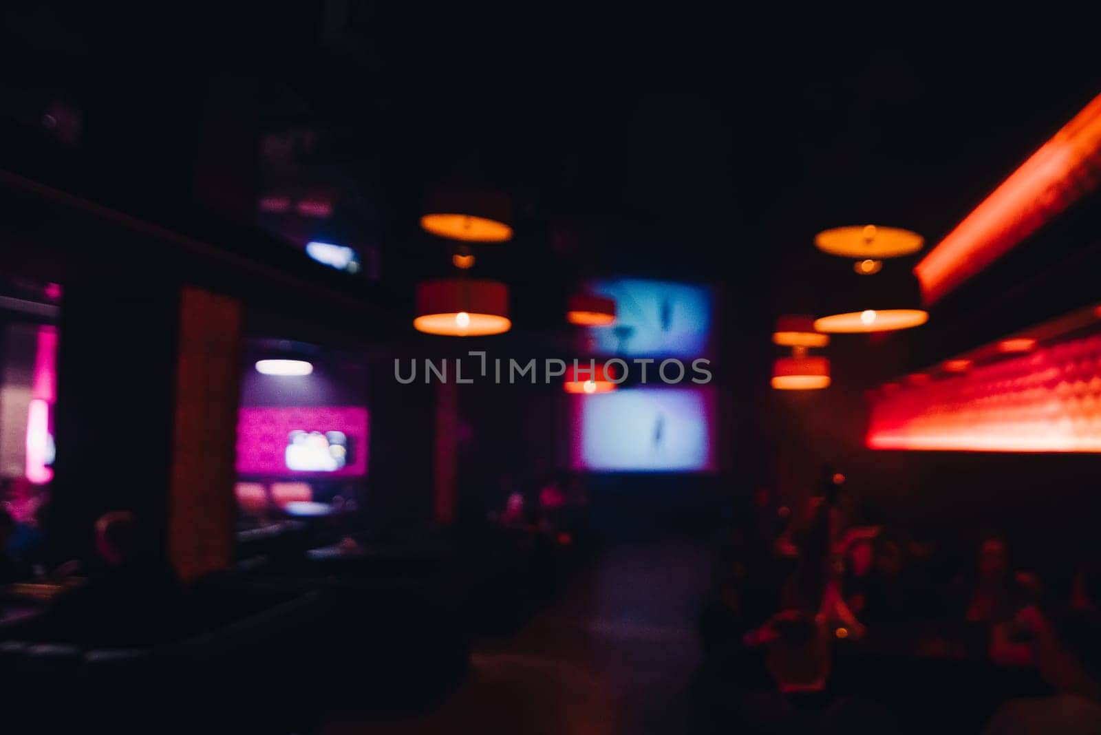 smeared and blurry background of night dark inerfere cafe with people out of focus