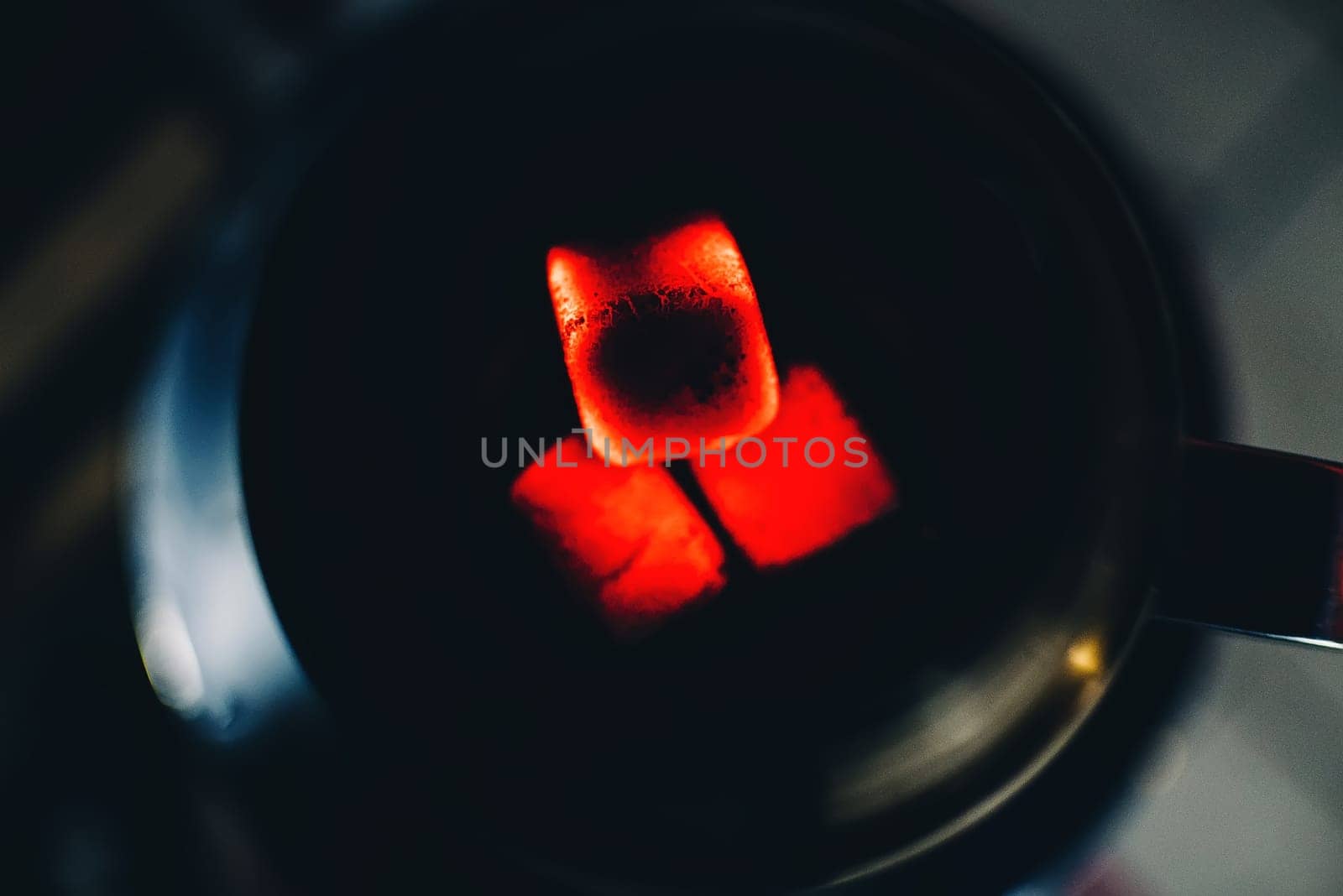 hot coals for Shisha bowl tobacco Smoking and relaxation closeup on dark background