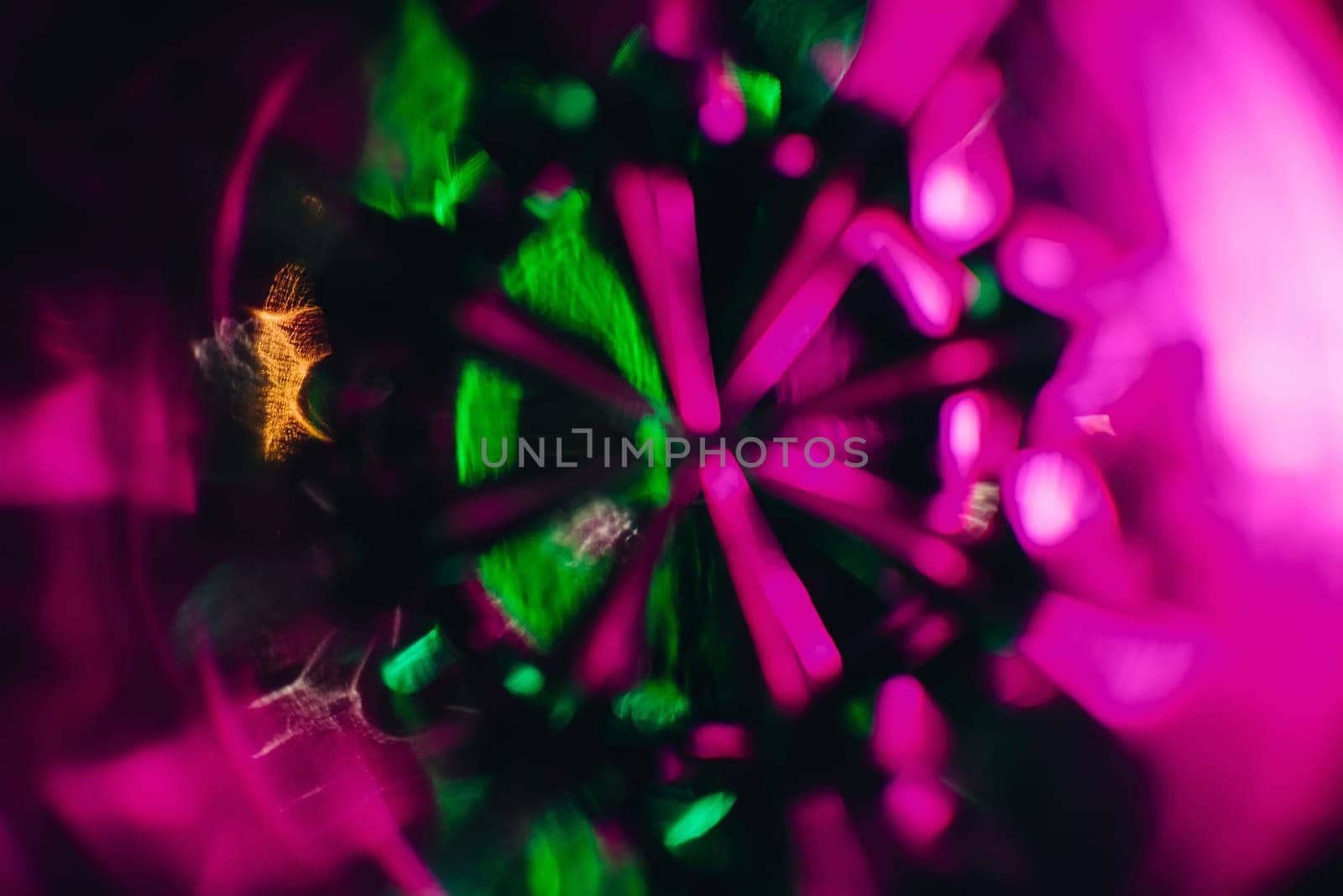 abstract art texture photograph through the glass Cup with pink purple and green glow to the background