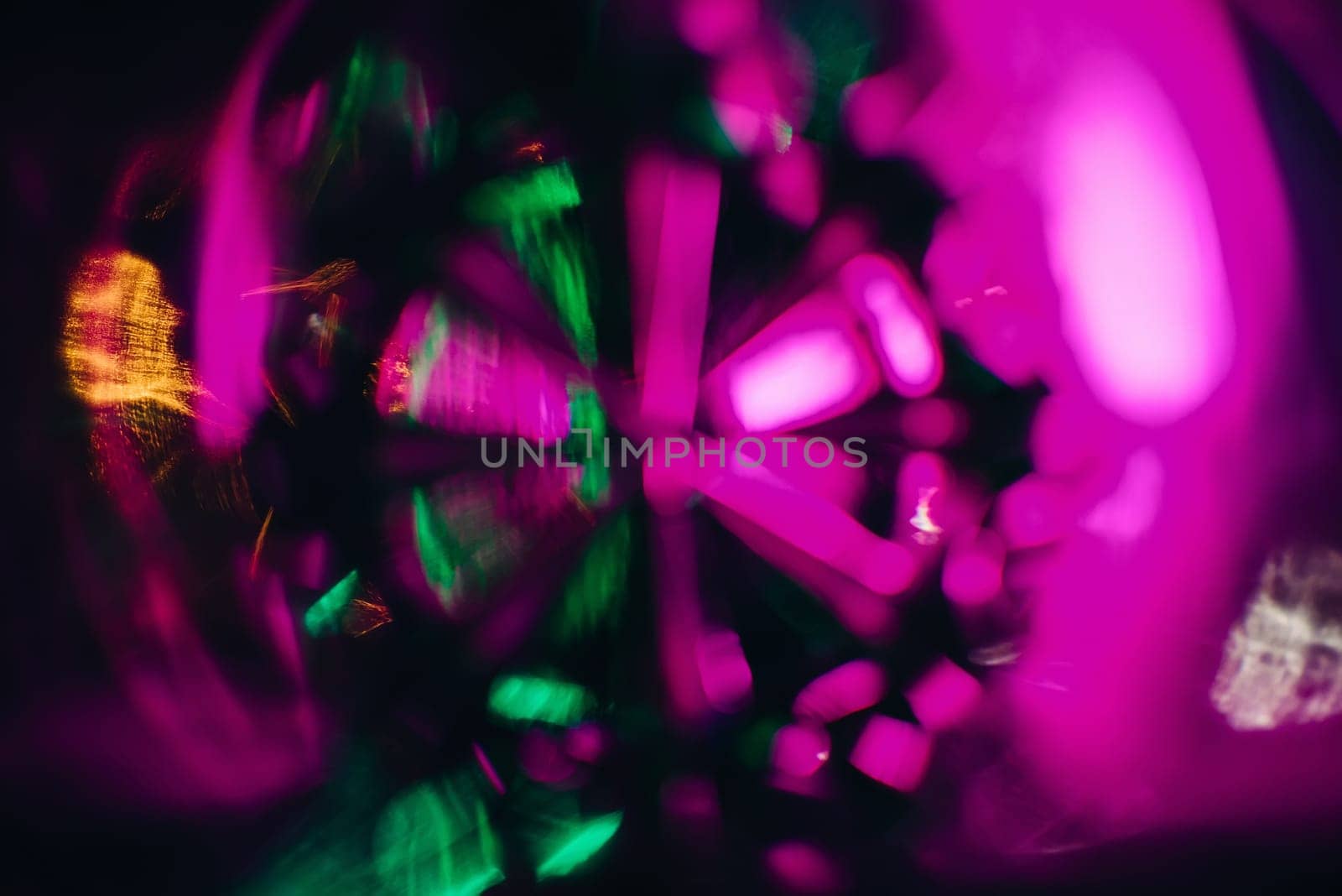 abstract texture pattern is photographed through the glass of the round glass green purple bright glow