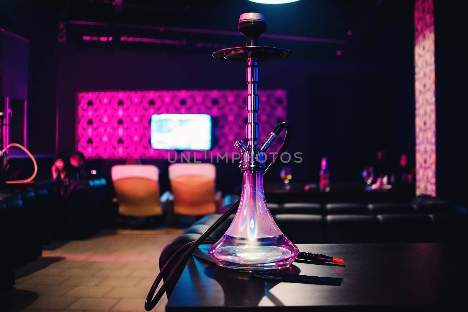 hookah glass bottle for Smoking tobacco in cafes on Desk with blurred background