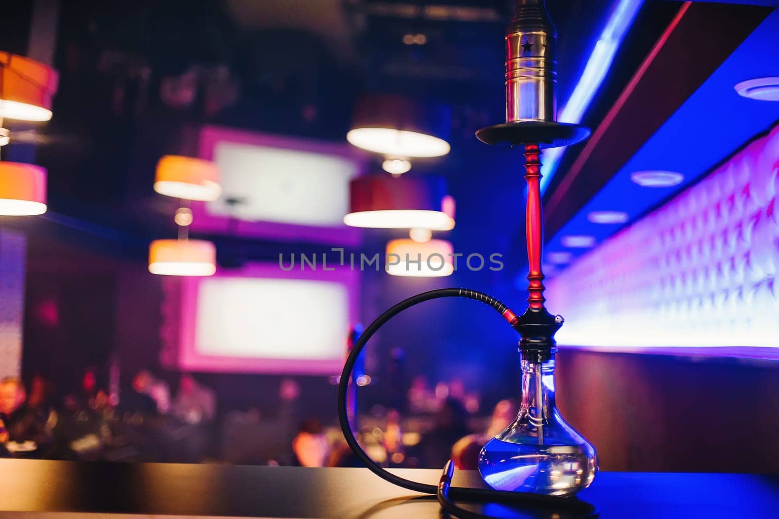 hookah bar with a nice clear bulb to Smoking tobacco and relaxing with blurred colorful background
