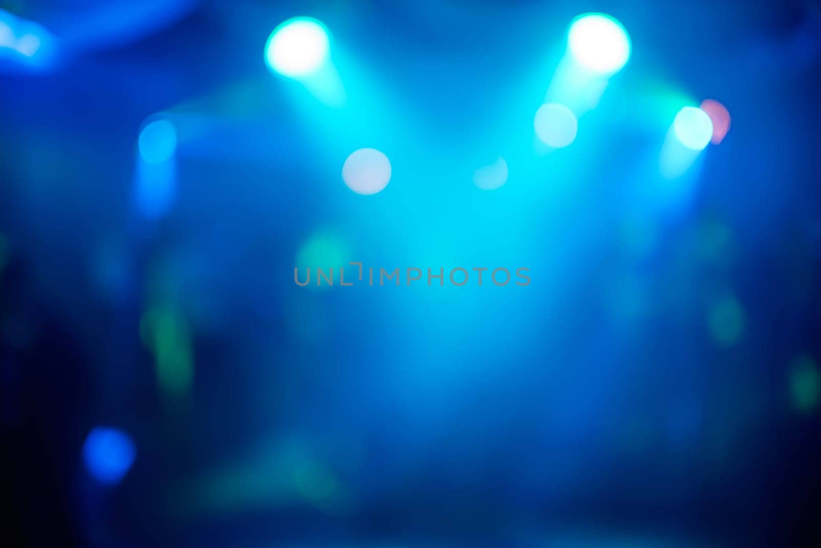 blue abstract blurred background with bright spots of light at the party