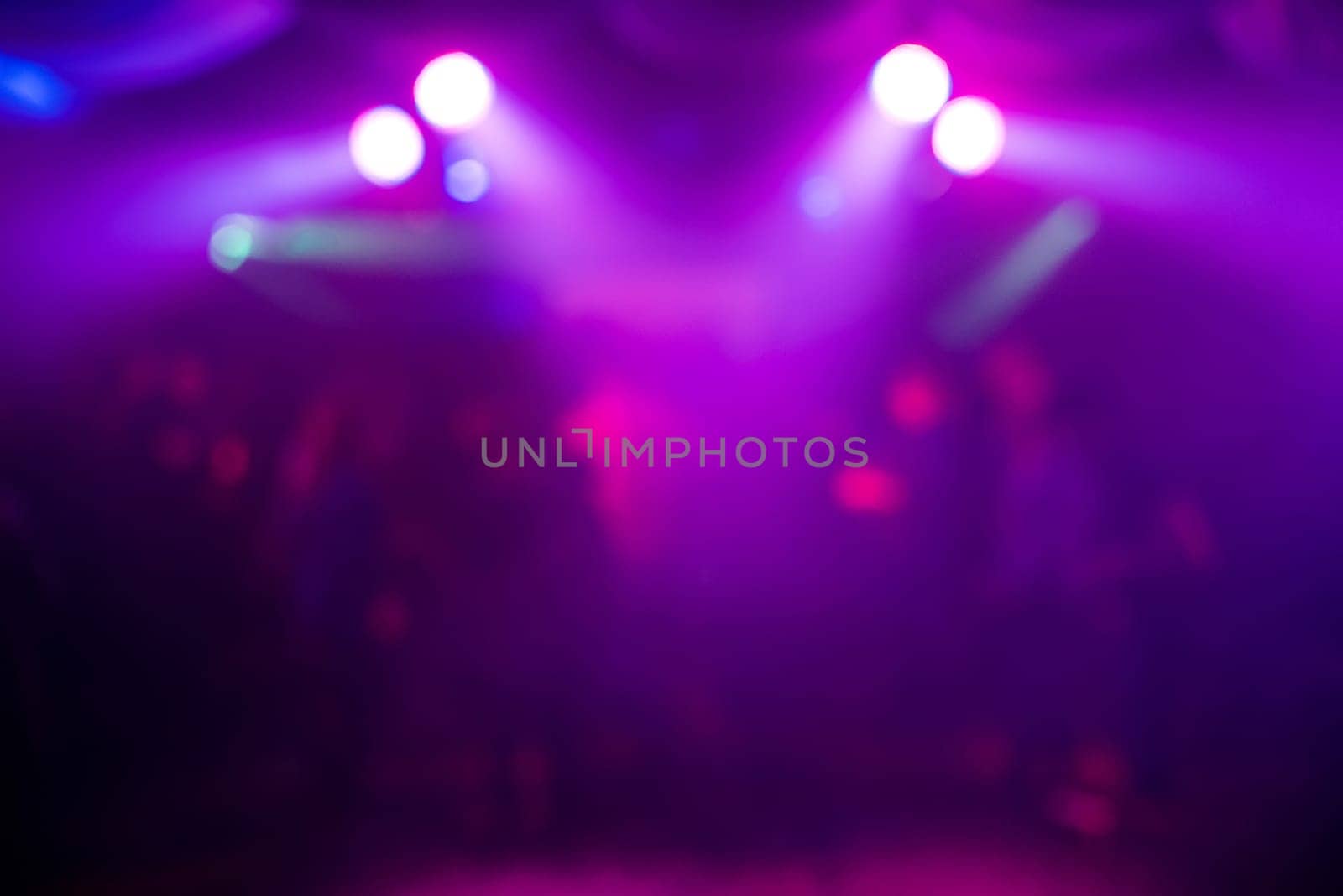 blurry purple background with abstract spots of light at night party