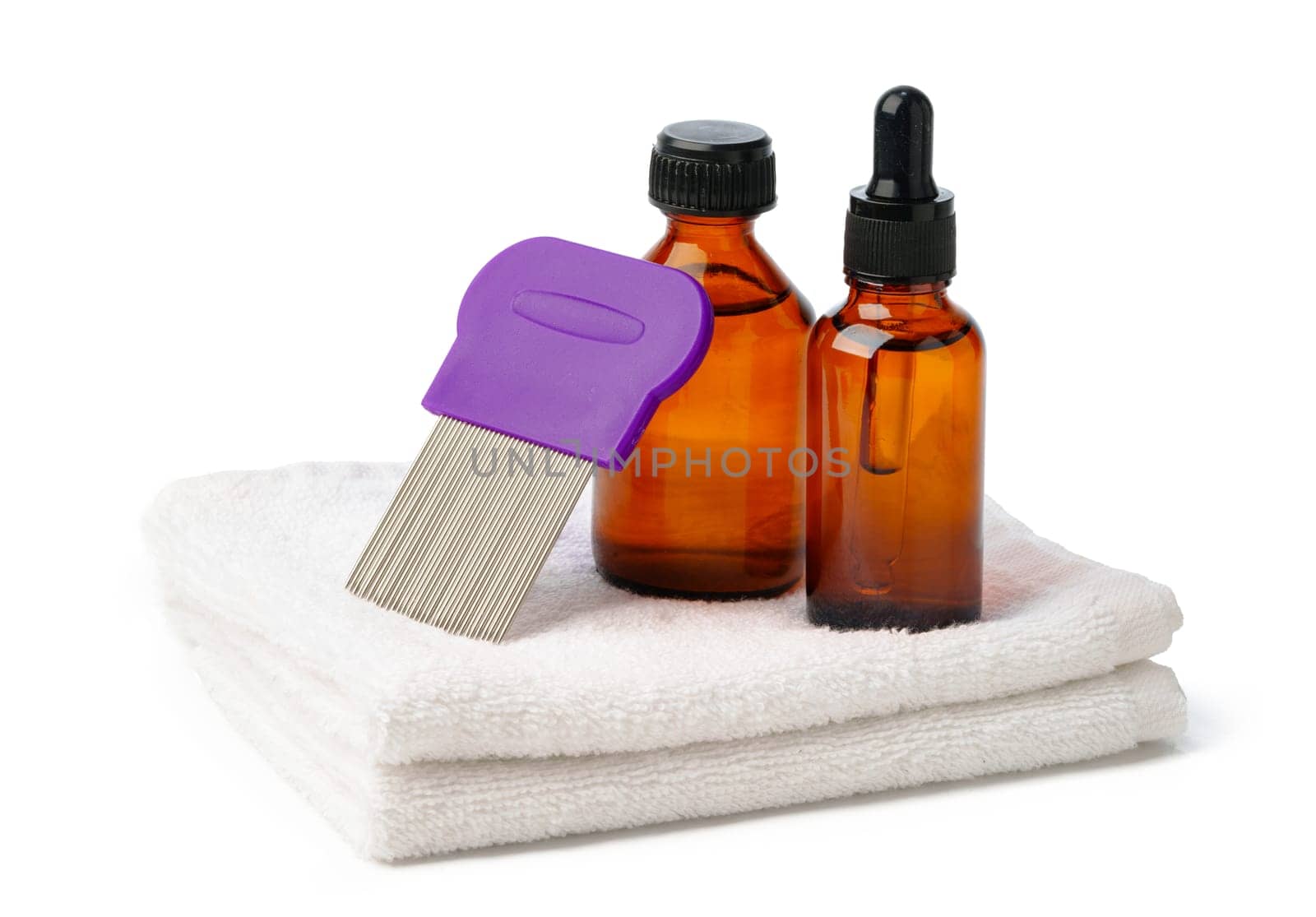 Comb, anti lice medicine and towel on white background close up