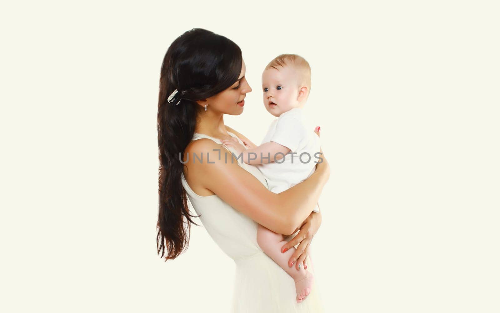happy young mother holding baby on white studio background by Rohappy