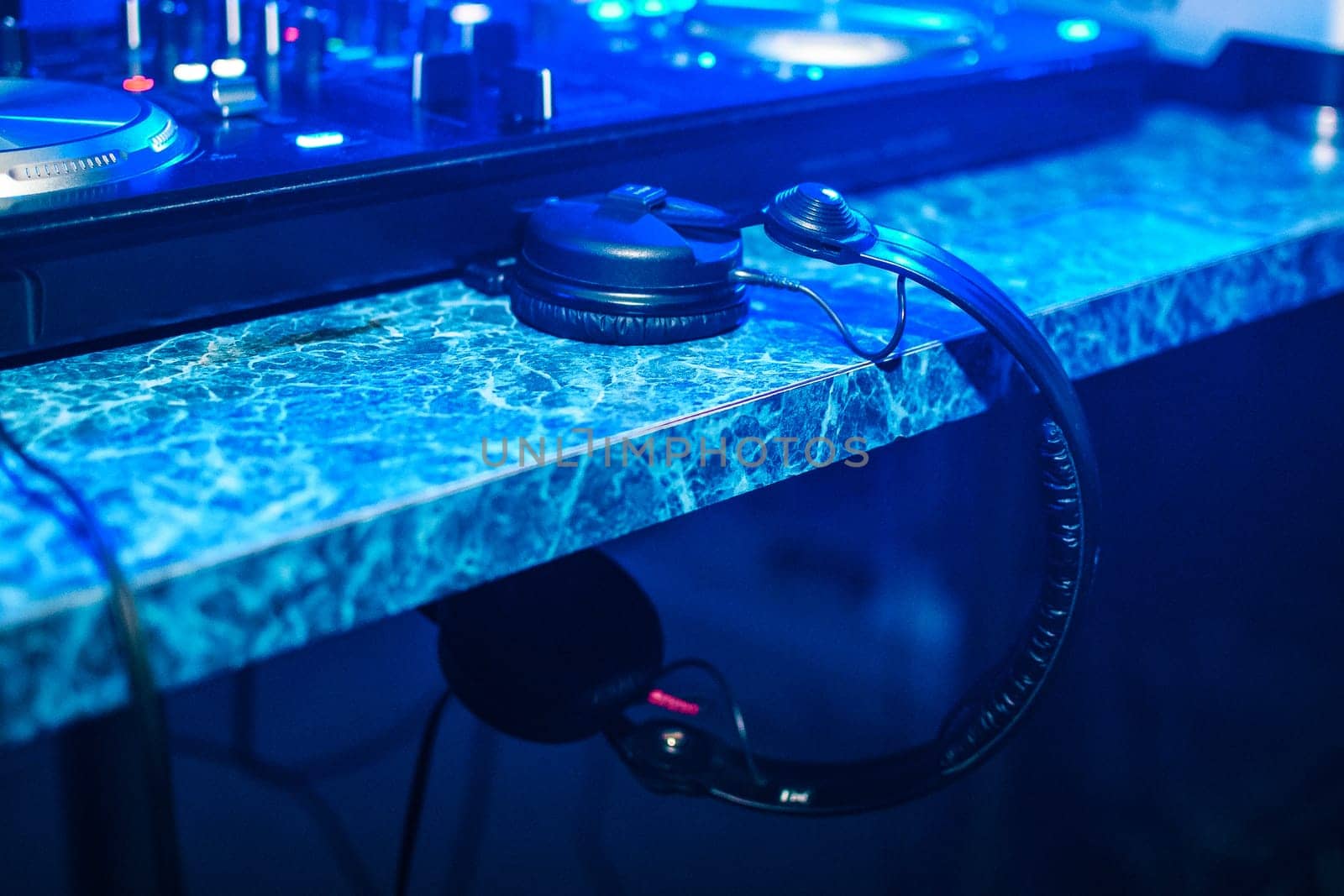 professional DJ headphones in a booth at party in nightclub