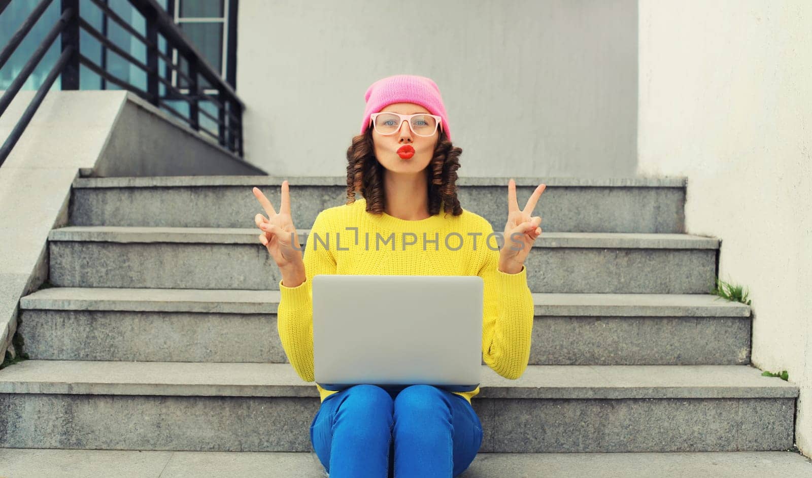 Portrait of modern cool young woman with laptop in the city by Rohappy