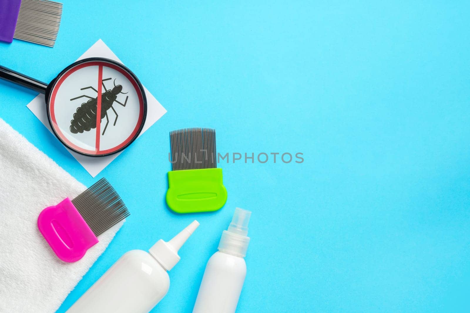 Anti lice equipment on blue background top view studio shot