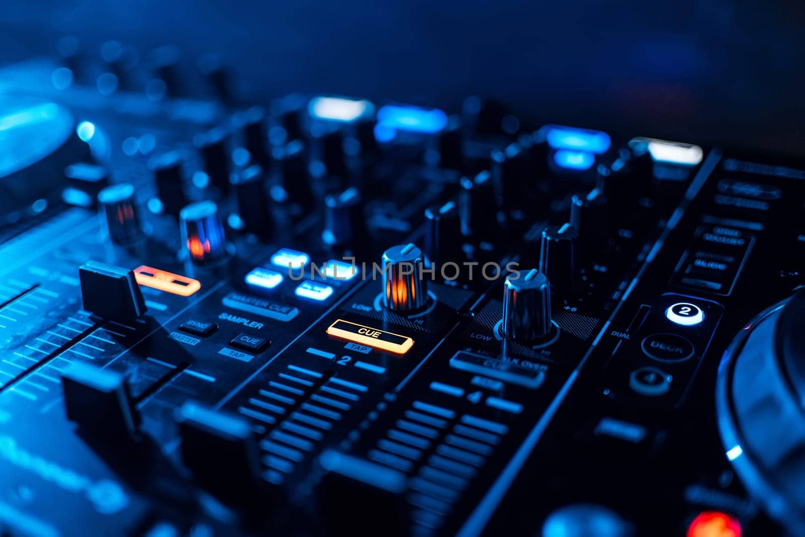 buttons and volume levels and mixing music on professional Board DJ to play music