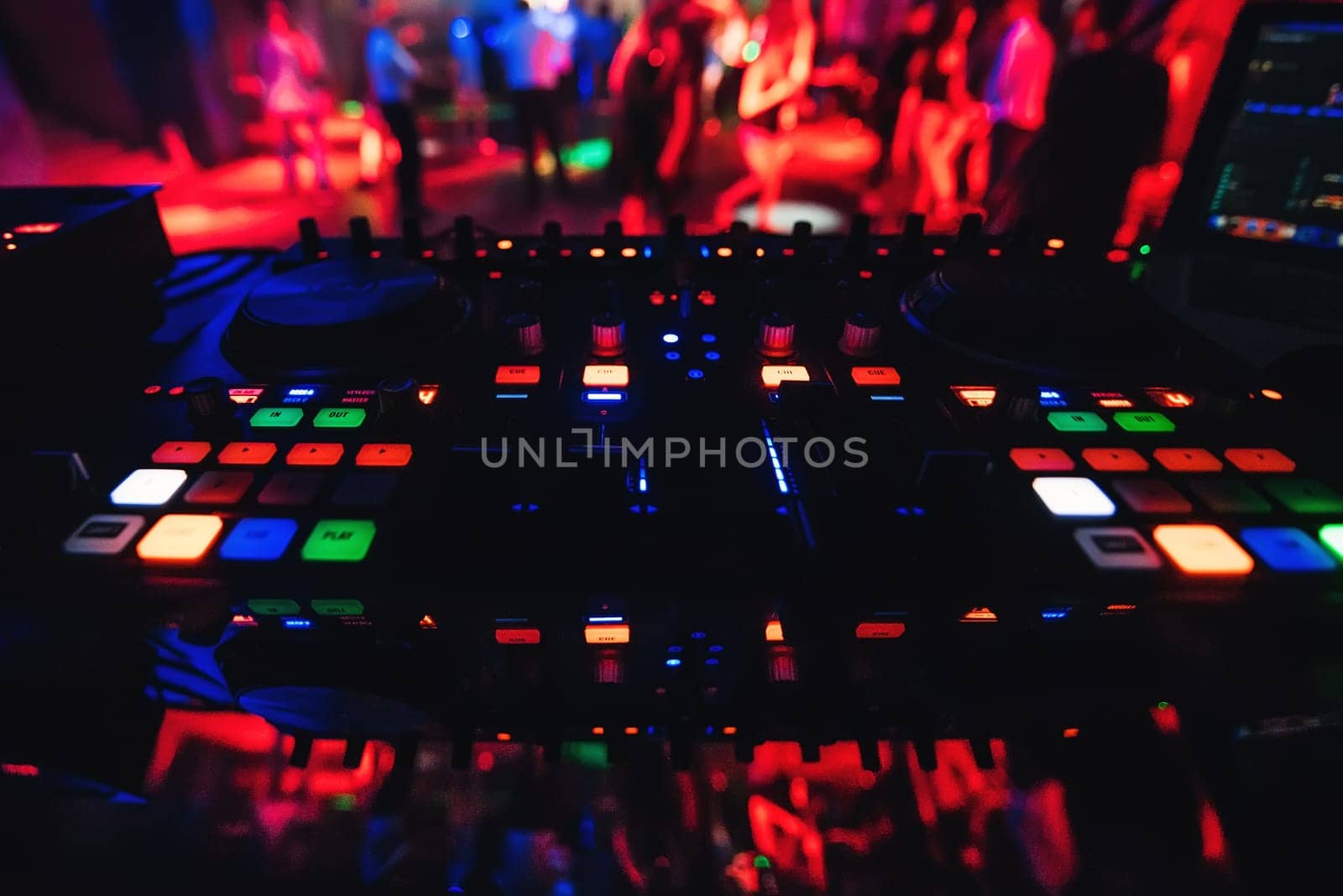 musical panel Board and a DJ for music DJ in a nightclub dancing with blurred people in the background