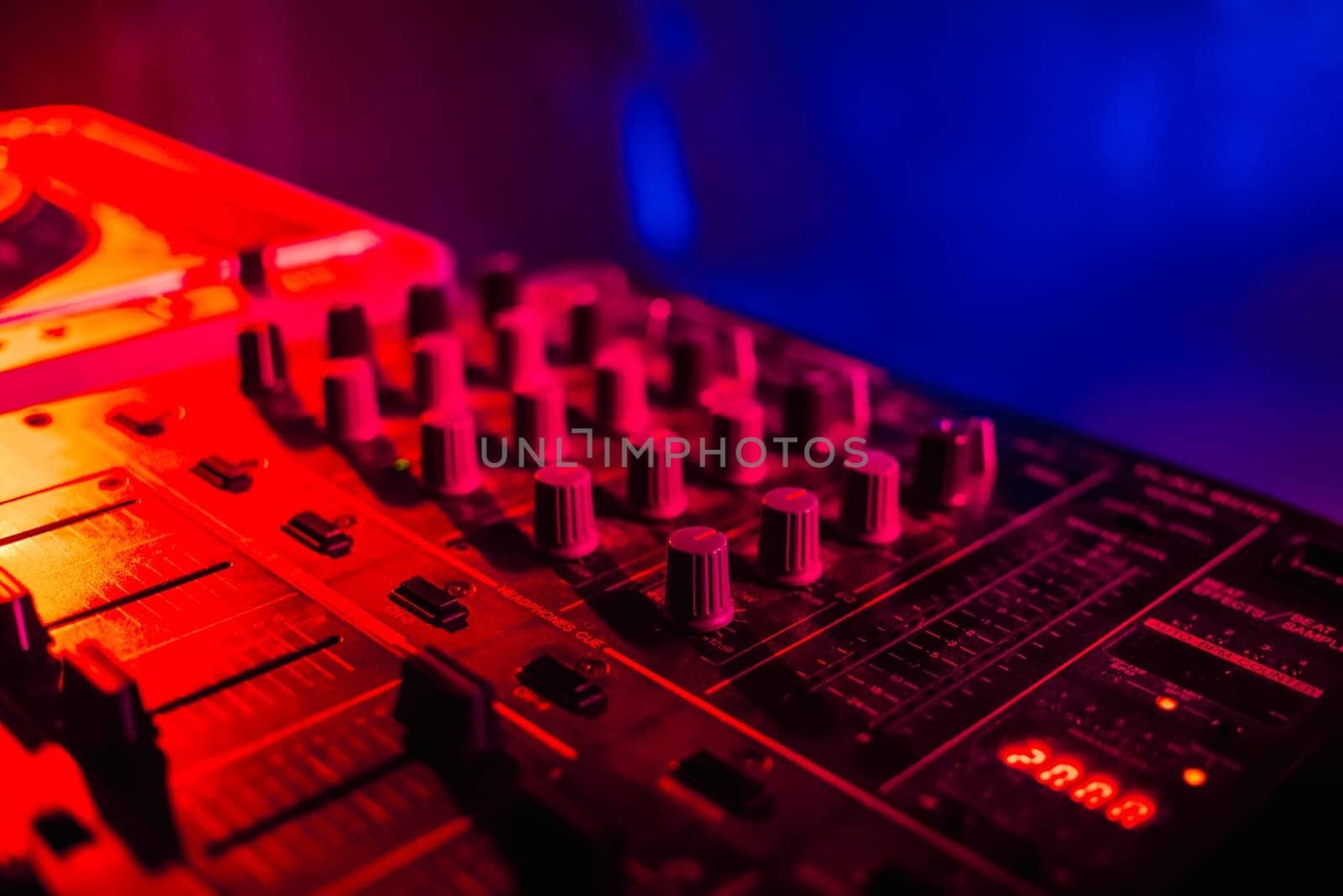 music dj panel mixer in a booth at a nightclub party