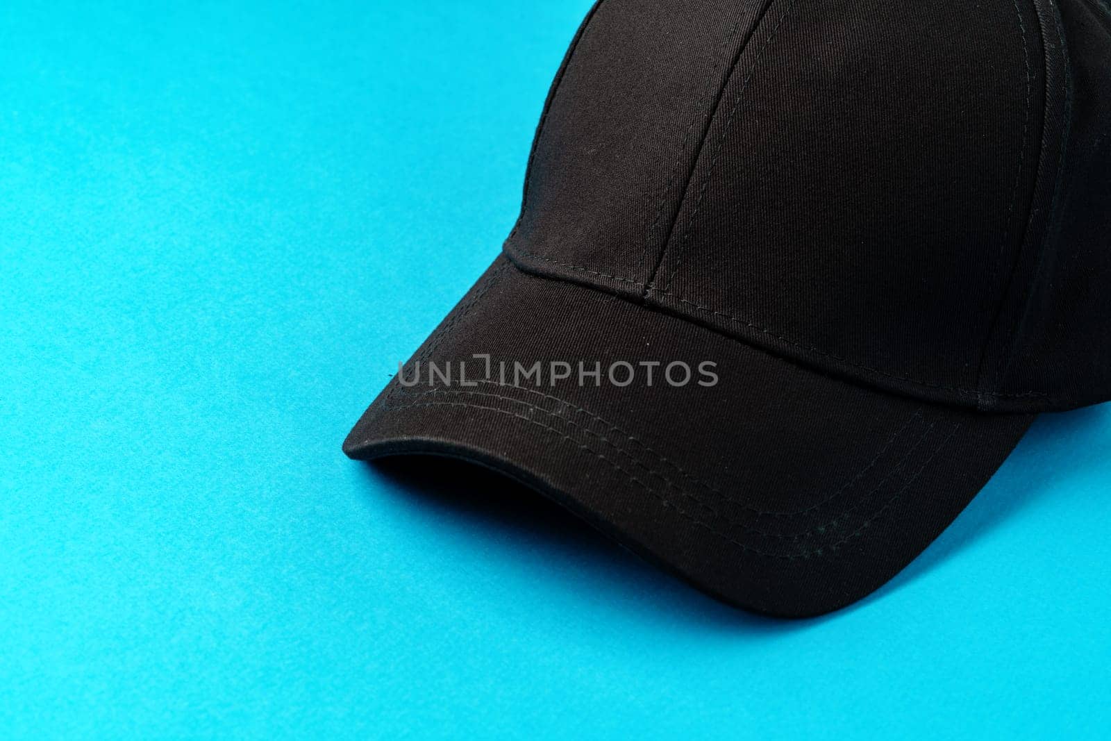 Baseball caps on blue background studio shot close up
