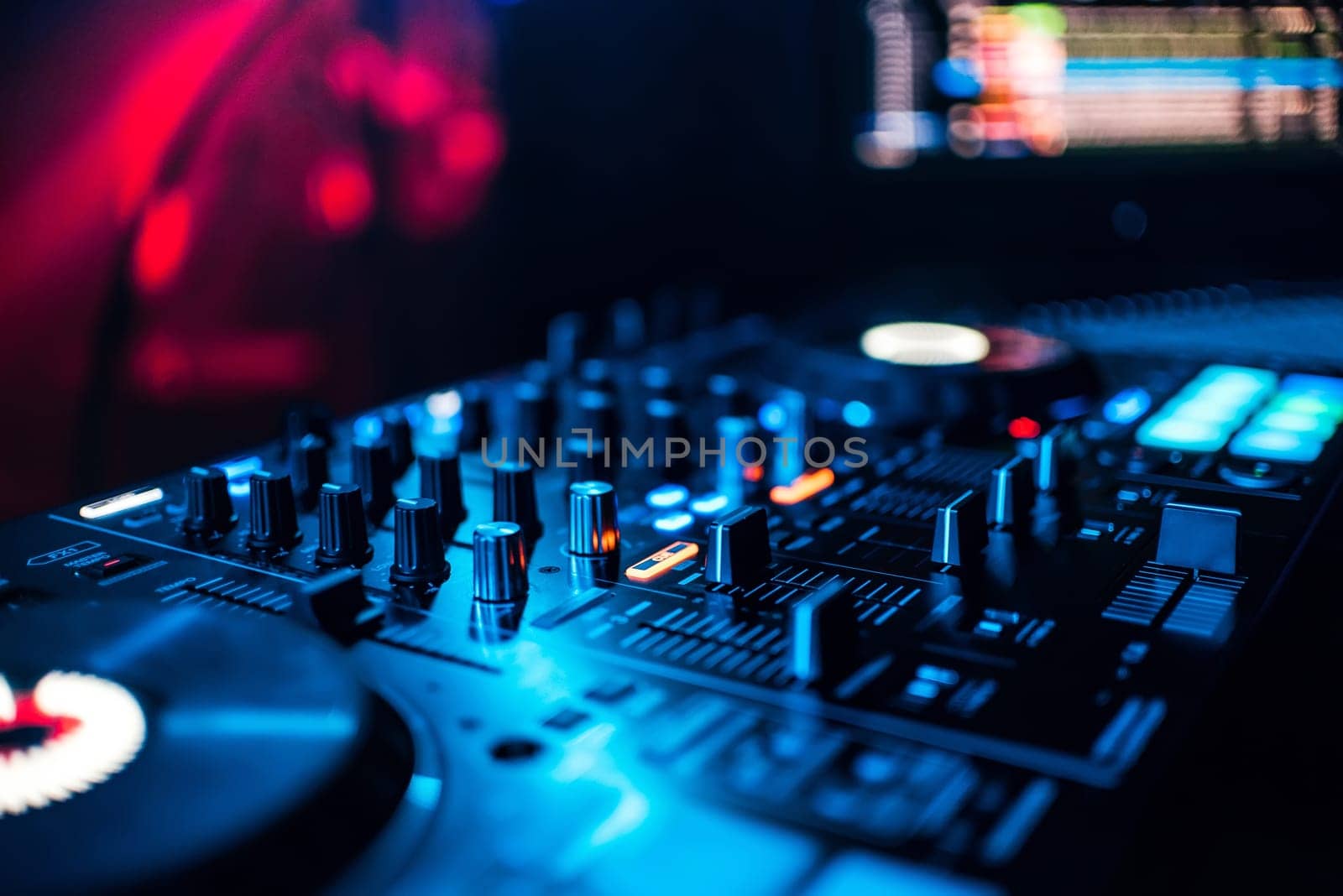 control buttons and mixing music on professional equipment for mixing and DJ