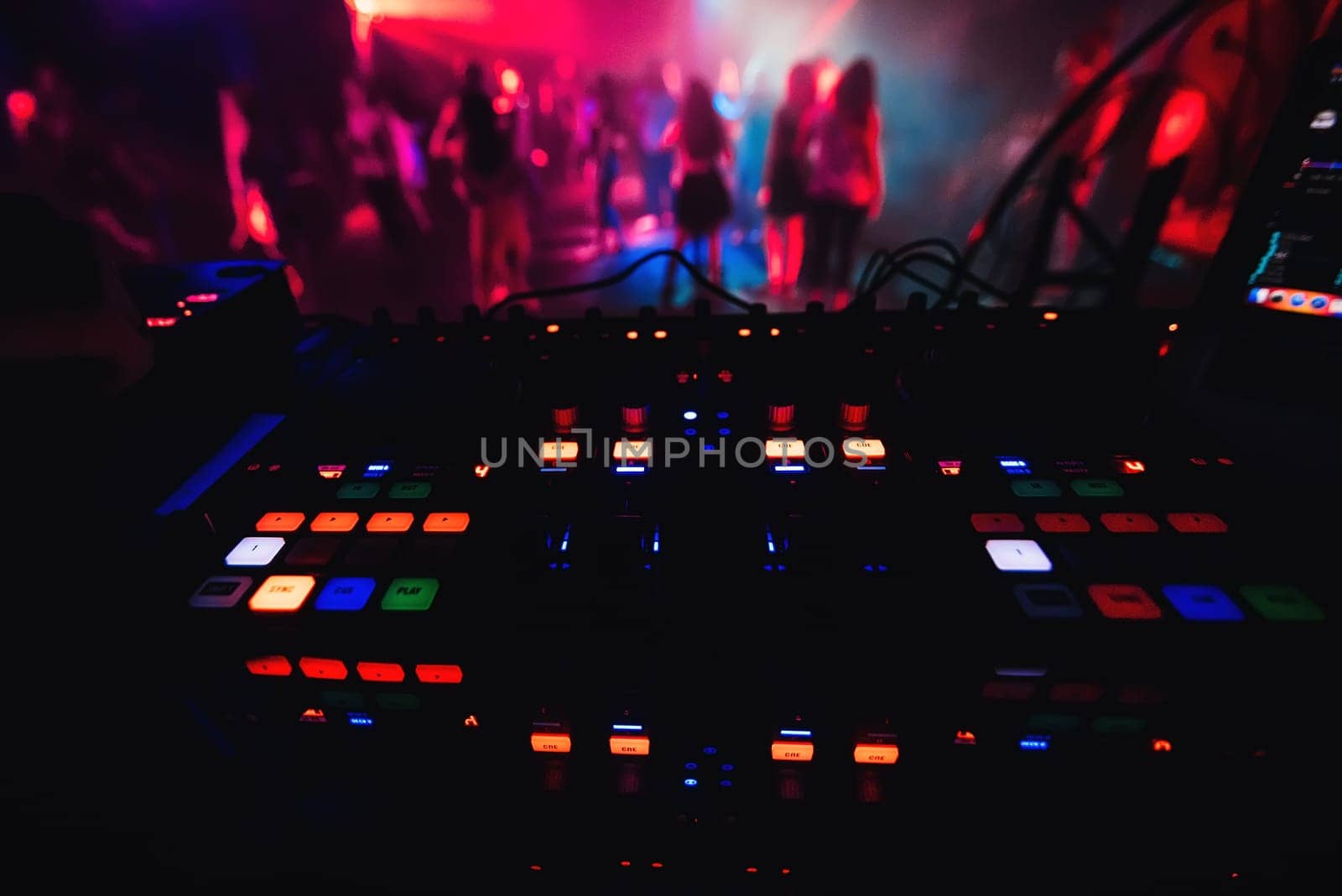 glowing colorful buttons on the mixer DJ party night club for dancing