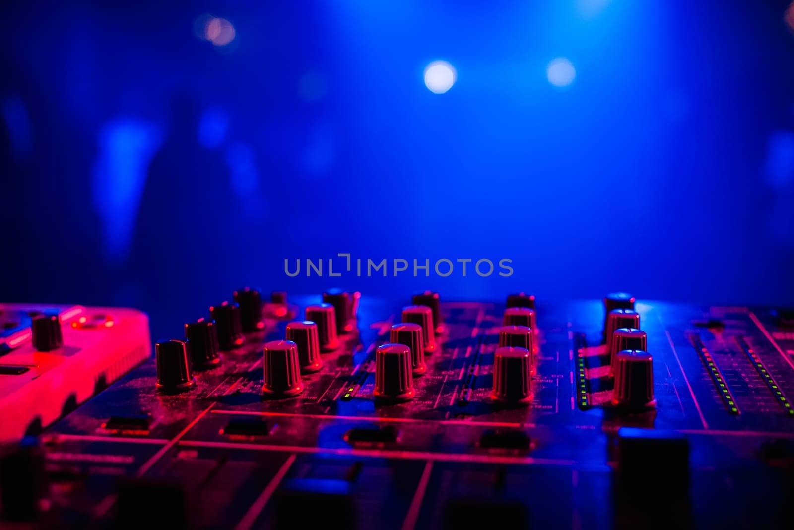 music dj panel mixer in a booth at a nightclub party