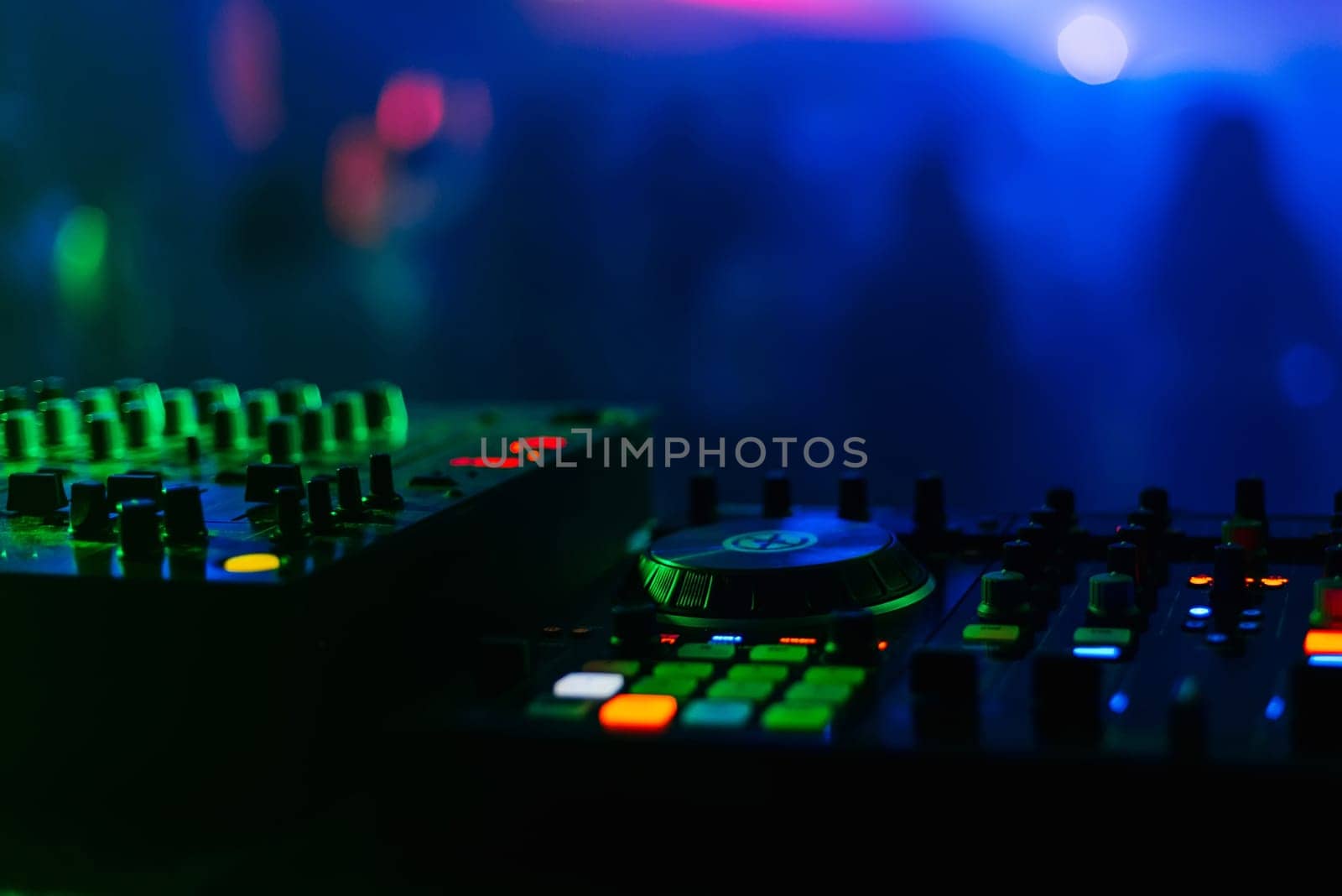 control panel and mixer DJ party night club under colorful lights