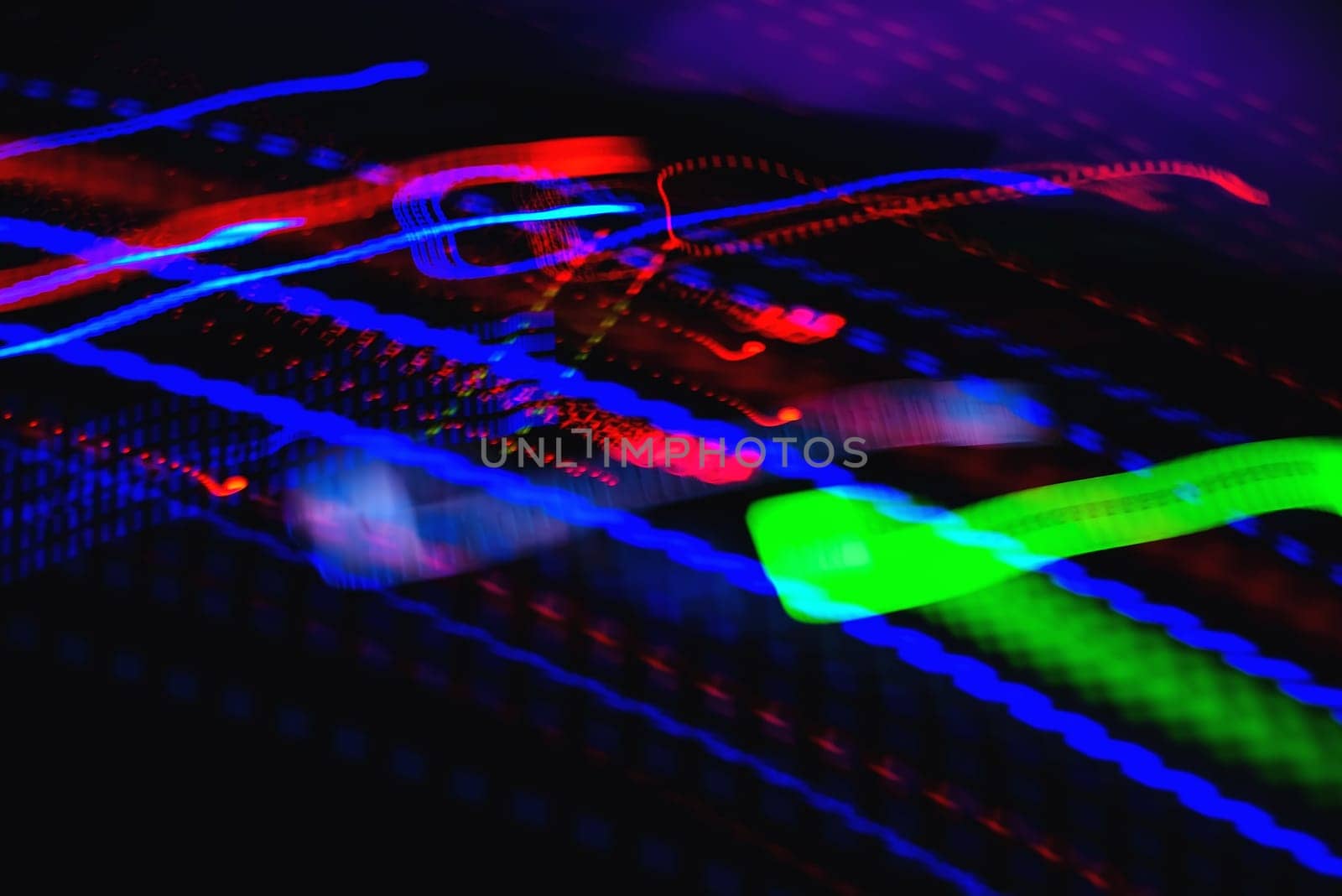 bright colored lines and trace using long exposure from musical equipment on a black background