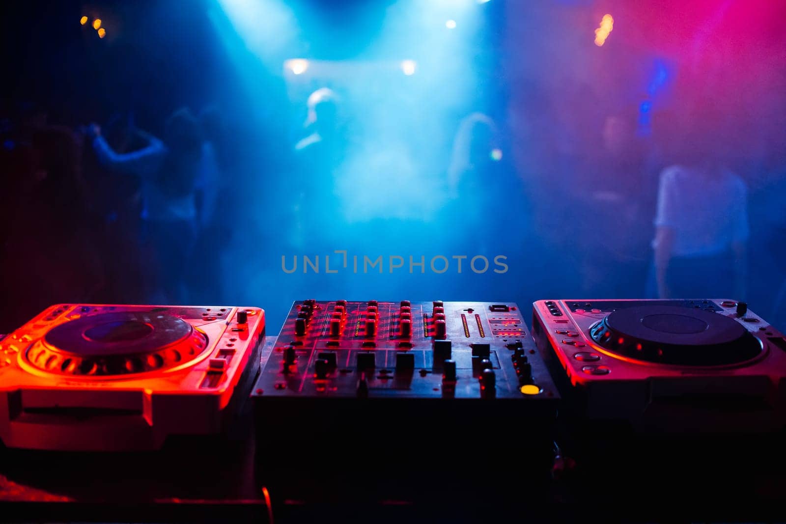 music dj panel mixer in a booth at a nightclub party