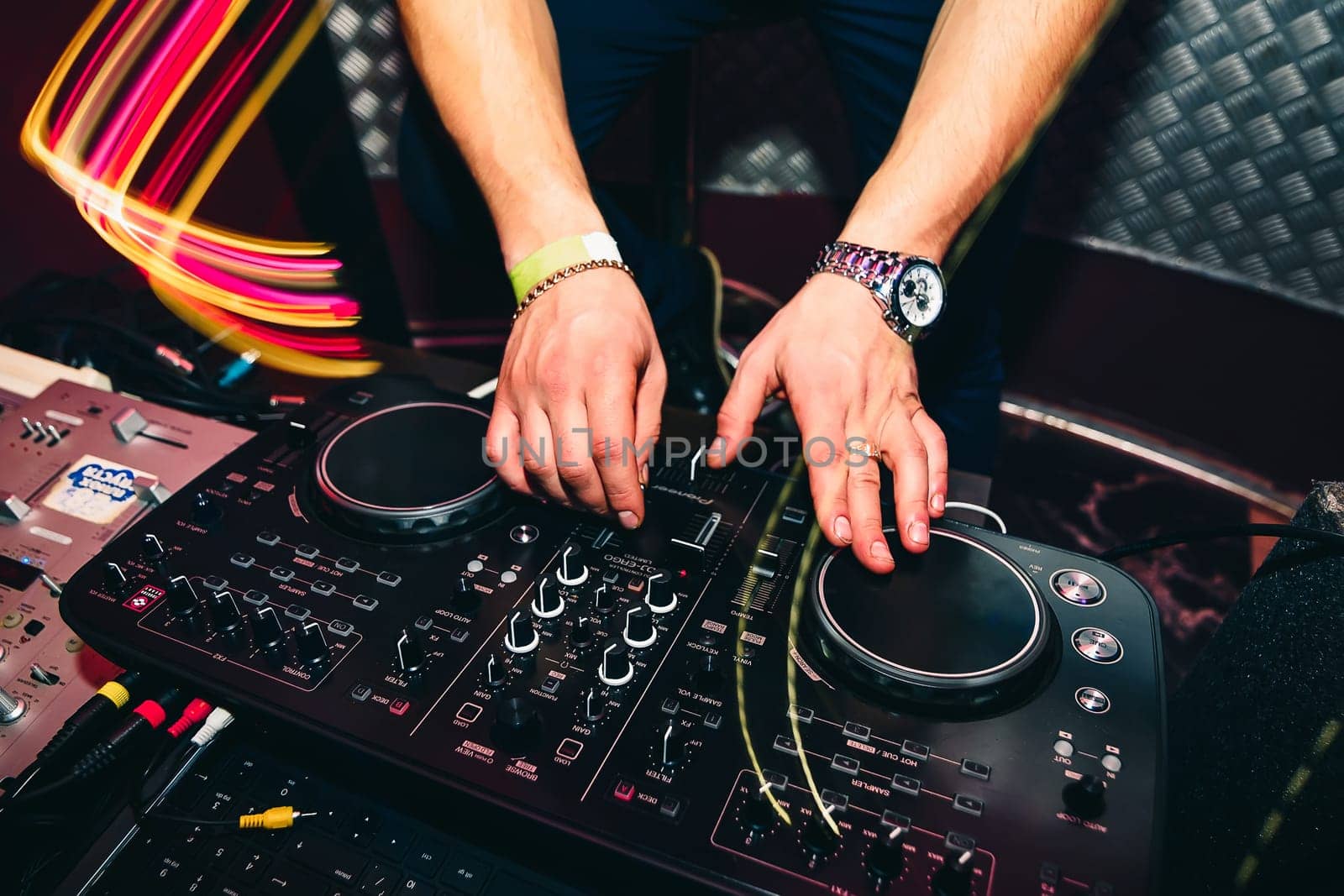 DJ brings the music and turns the volume on musical equipment