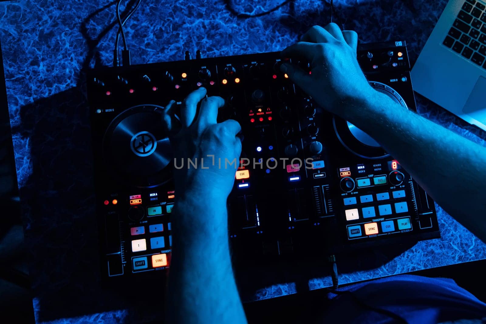 mixer and DJ booth in the nightclub with hands in night club on party