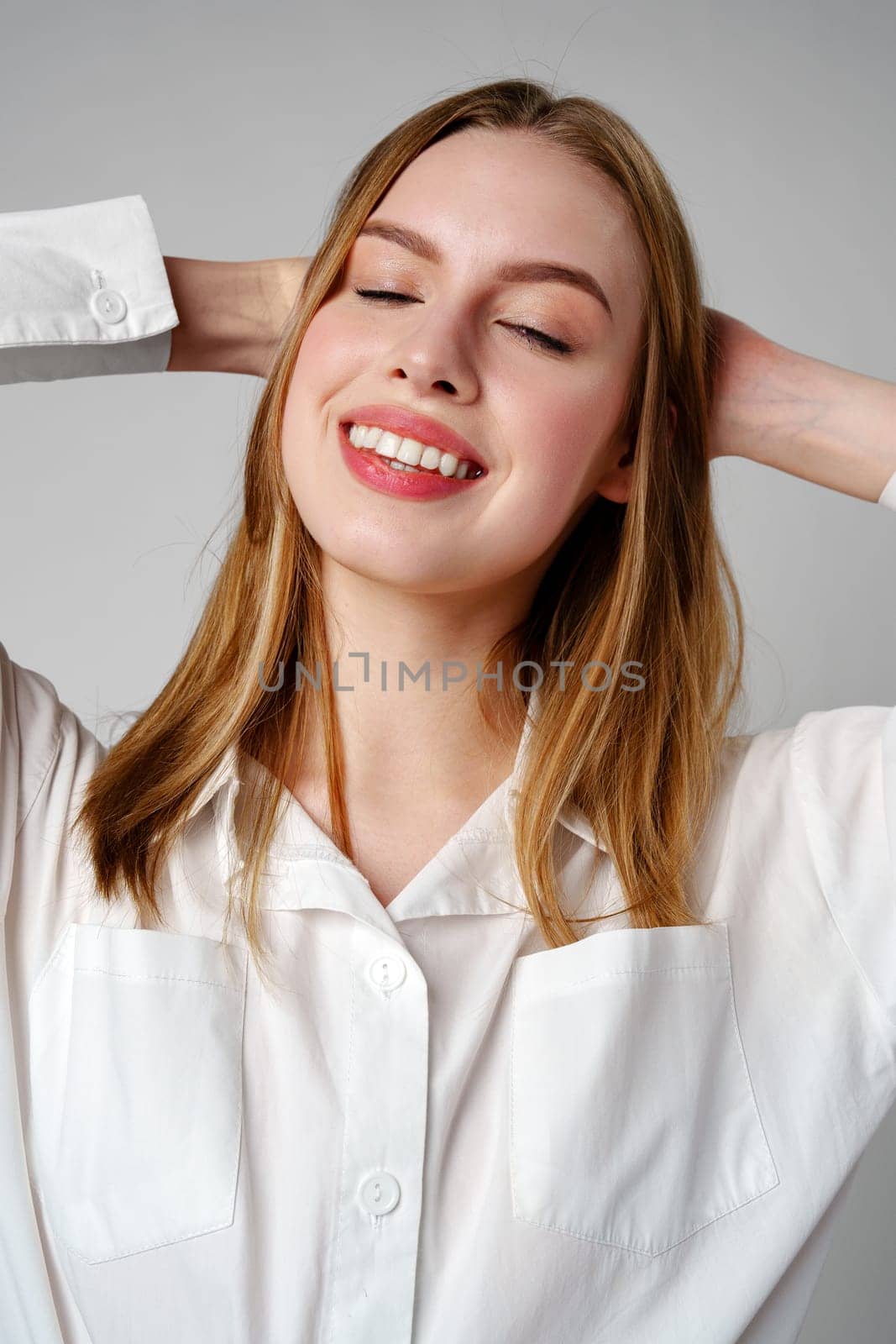 Young Woman in White Shirt Posing for Picture by Fabrikasimf