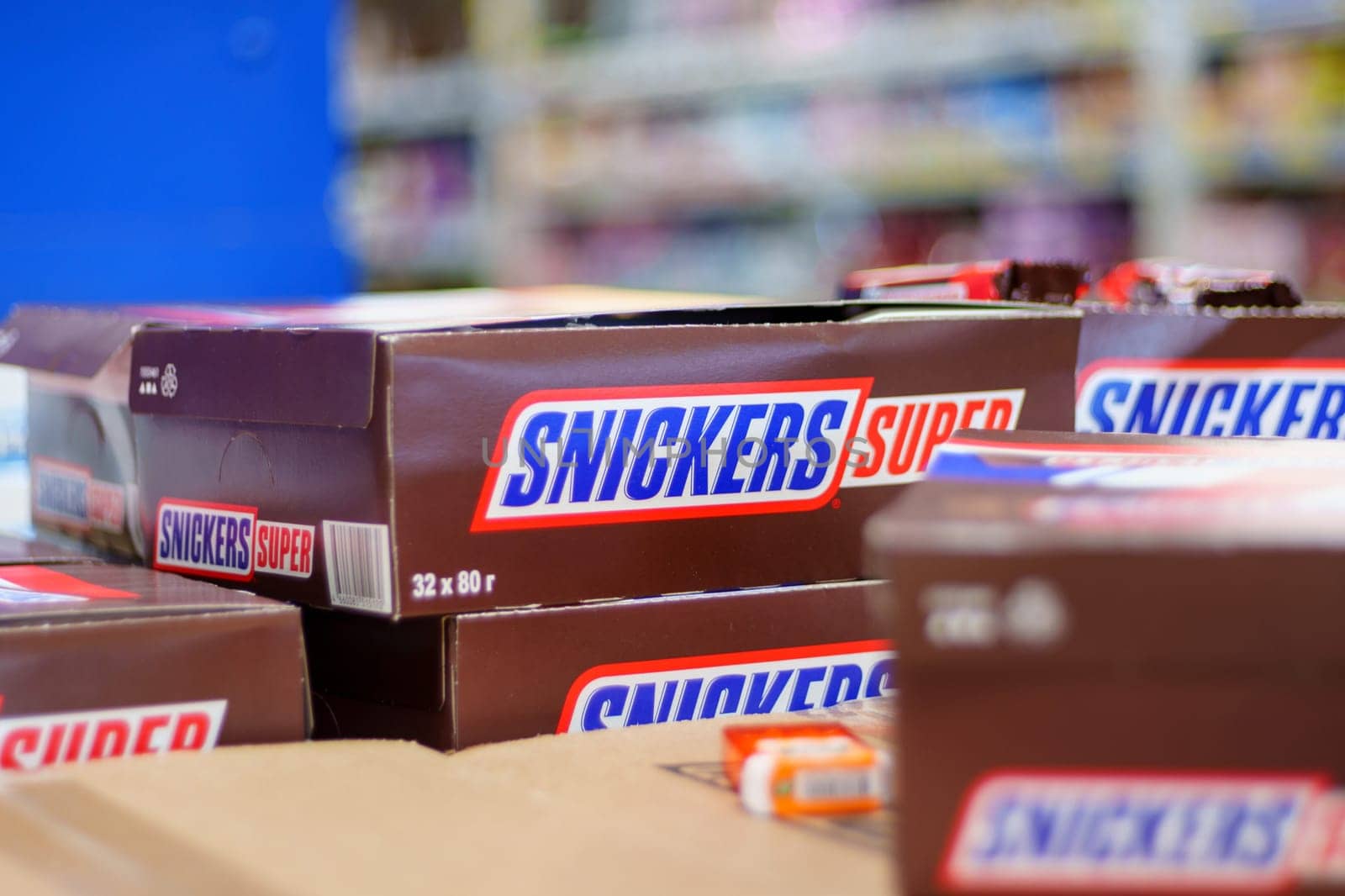 Tyumen, Russia-March 02, 2024: Snickers chocolate bars lined up enticingly on a store shelf, remains on the delicious treats waiting to be picked. by darksoul72
