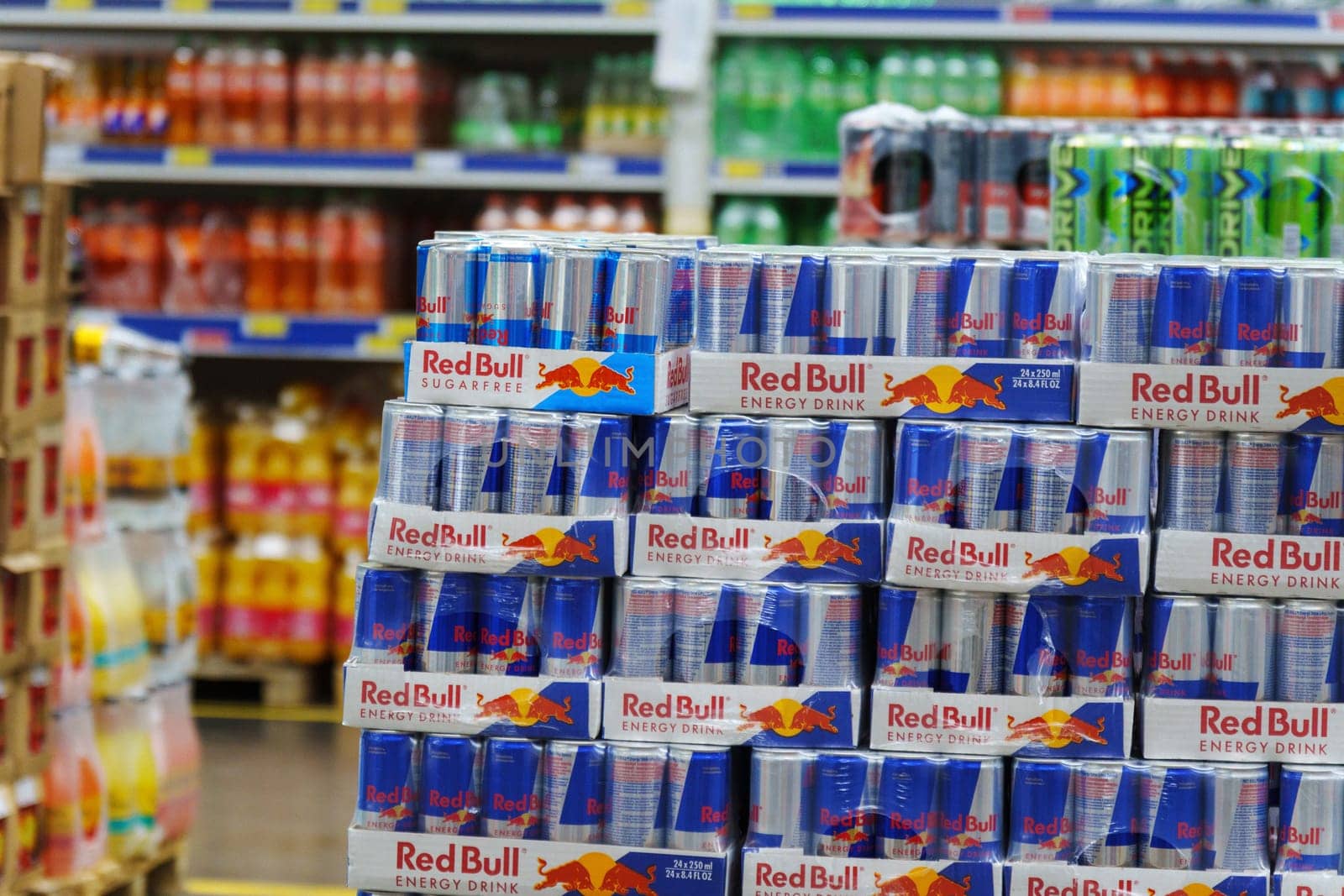 Tyumen, Russia-March 02, 2024: Display in a store is overflowing with cans of Red Bull energy drink, neatly stacked and organized to attract customers.