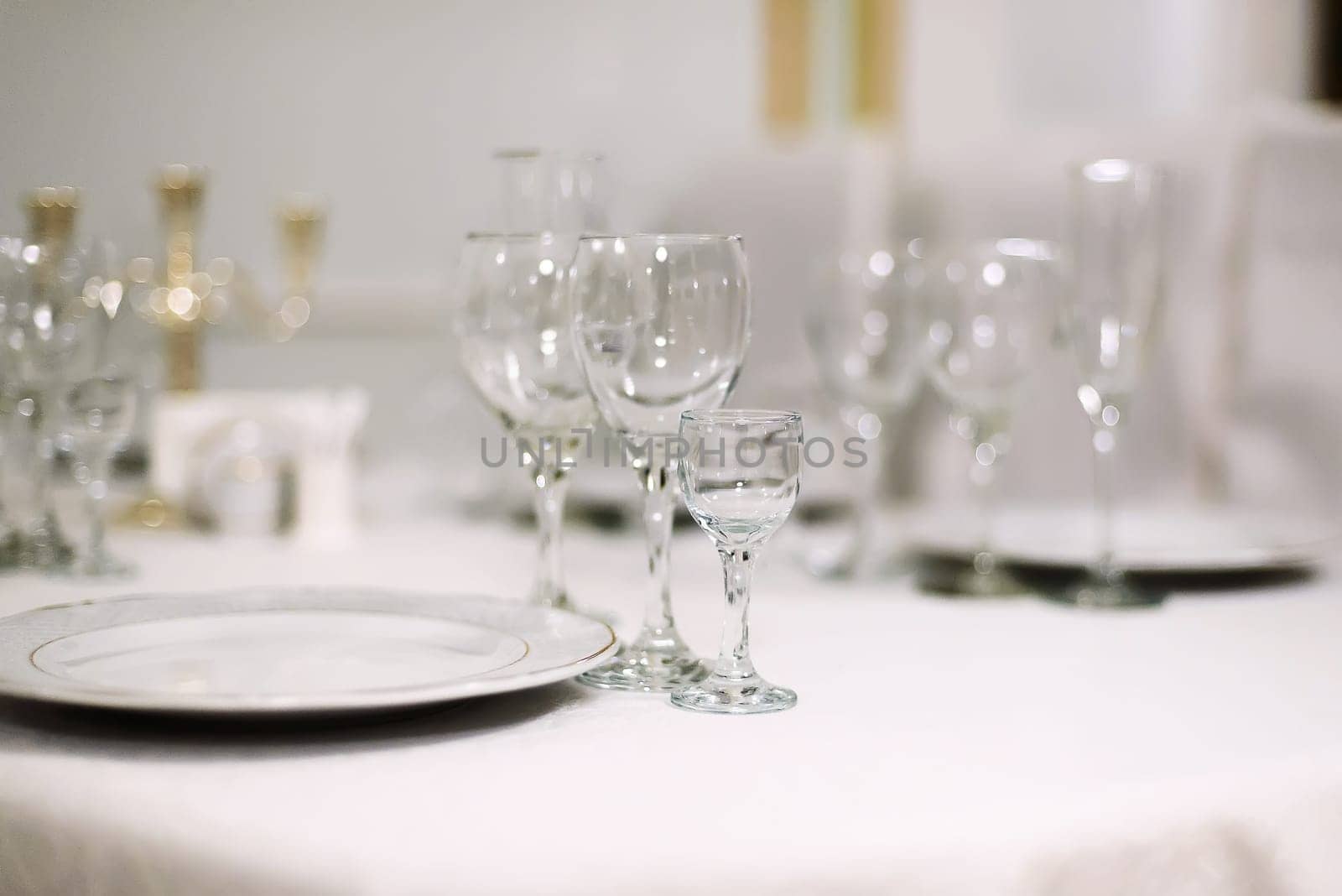 glasses for alcoholic beverages on the festive table in the restaurant