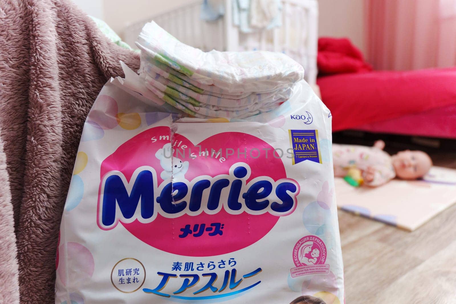 Tyumen, Russia-March 02, 2024: Merries diapers is placed on top of a wooden table, showcasing the brands logo and packaging design. by darksoul72