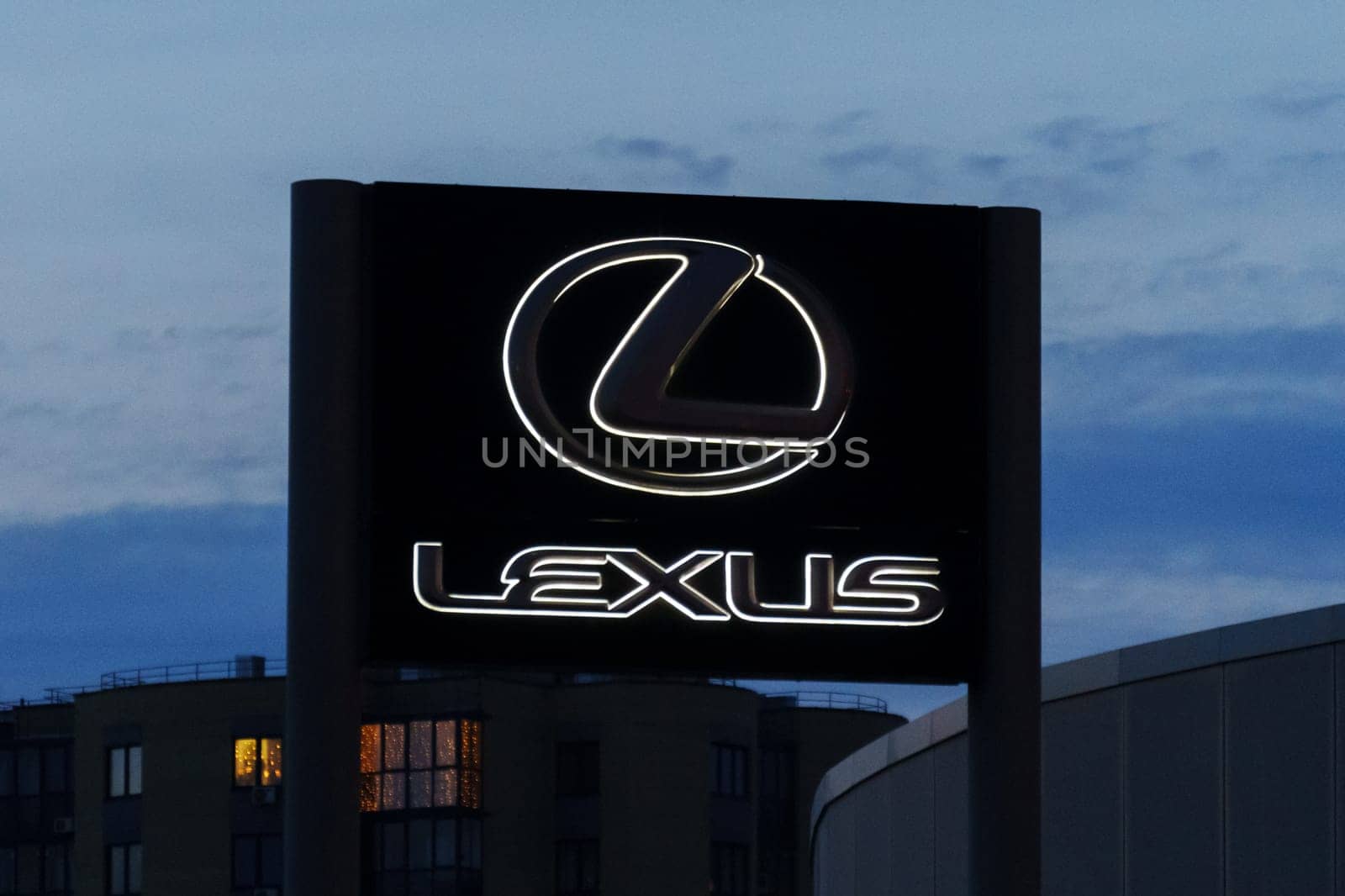 Tyumen, Russia-March 18, 2024: Sign displaying the Lexus logo for a car dealership stands prominently in front of a building.