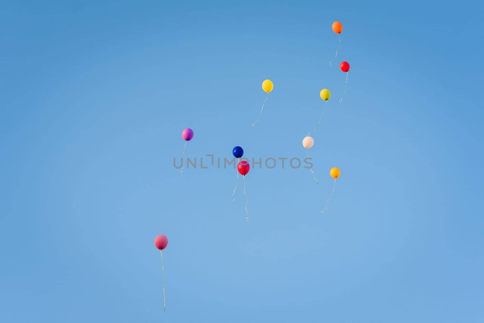 group of air colored gel balls flying against the sky