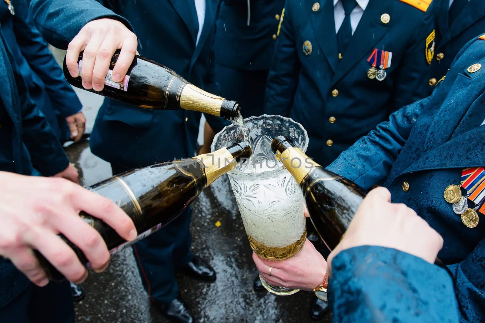 Russian uniformed policemen celebrate and drink champagne