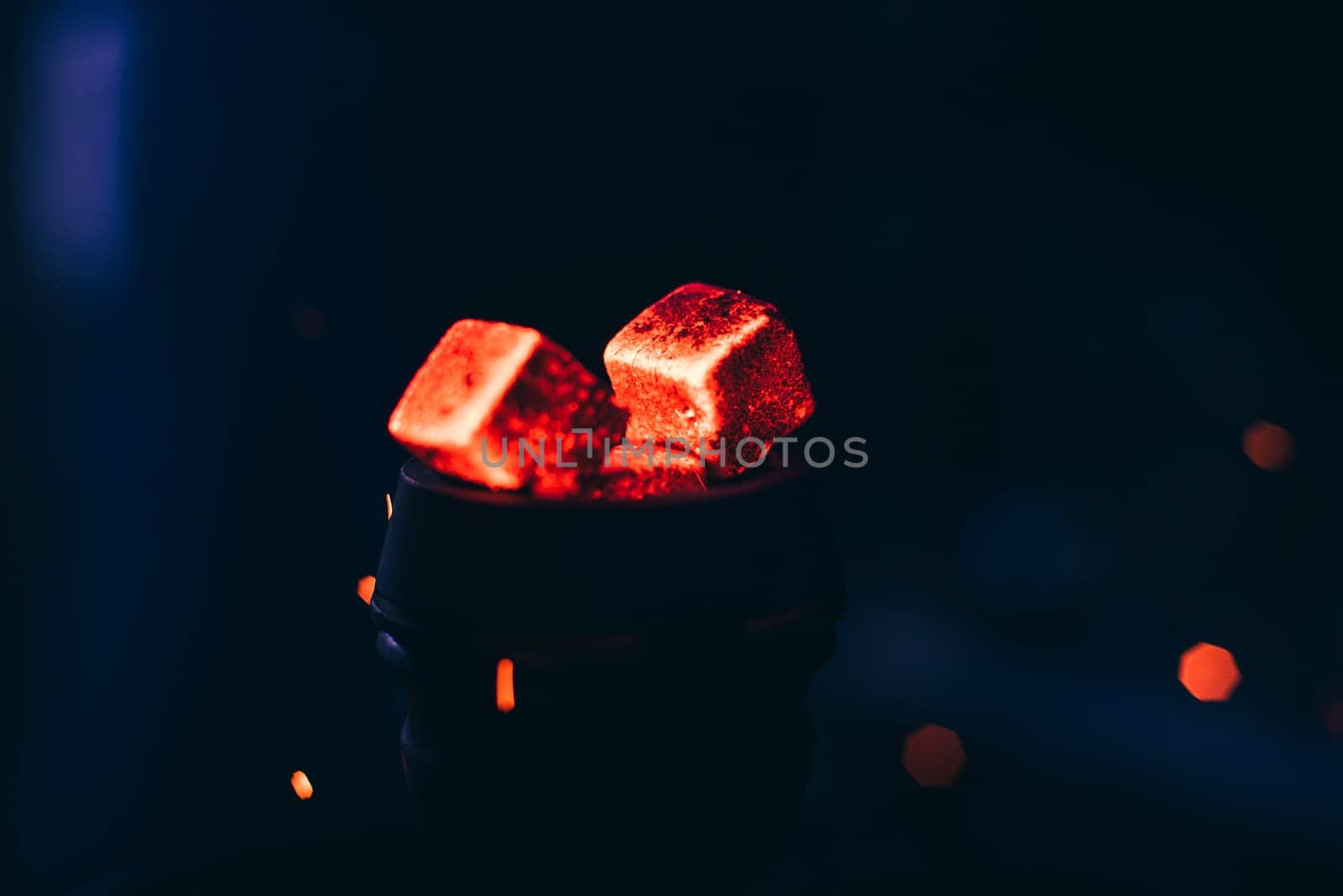 hot red coals with hookah sparks in metal bowl for Shisha Smoking and traditional Asian relaxation