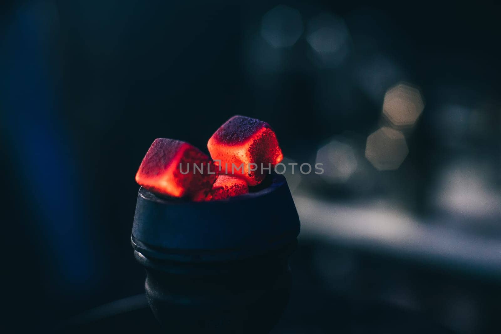 hot red coals with hookah in bowl for Shisha Smoking and traditional Asian relaxation close up