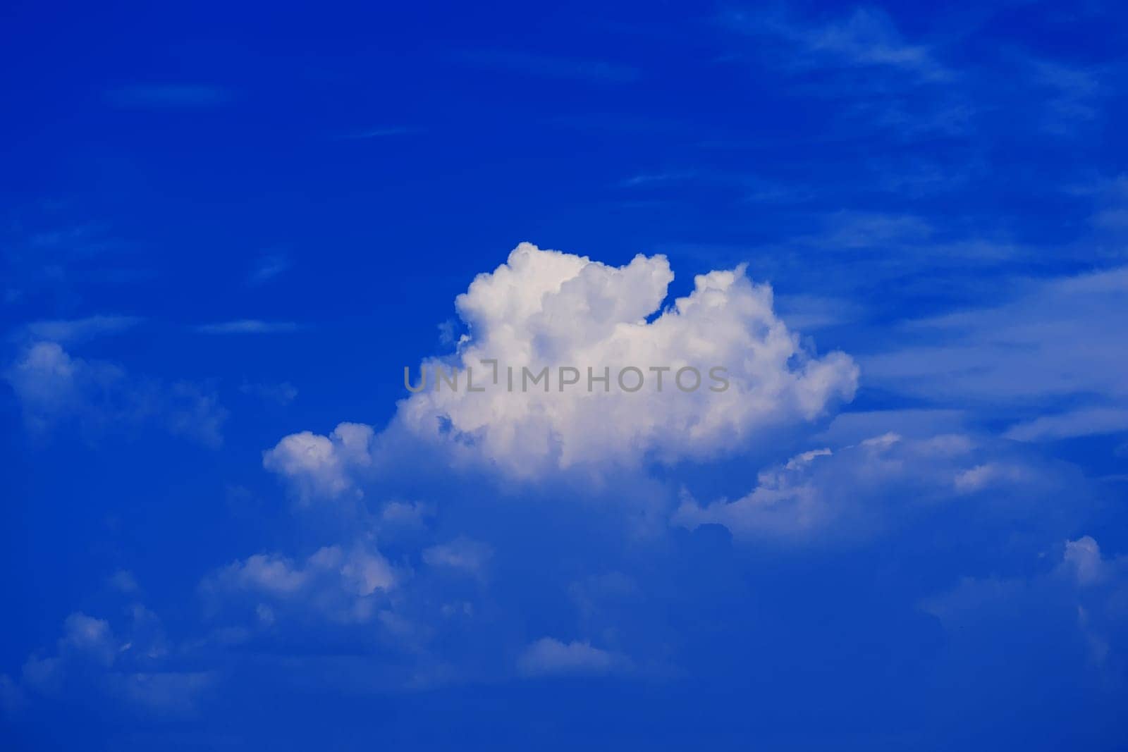 blue clear sky with white fluffy clouds in the background