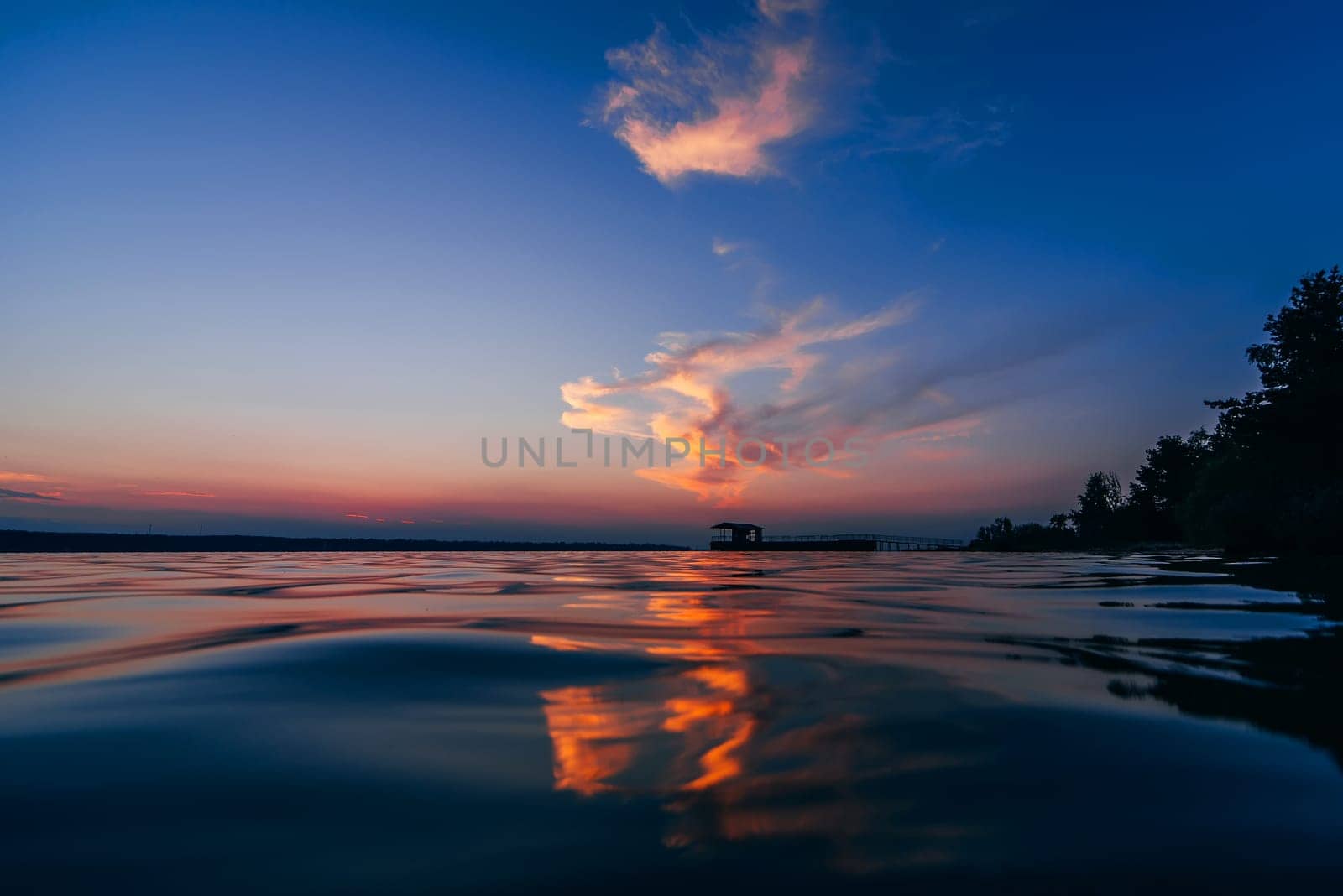 red blue sunset with beautiful reflection in the water waves of the sea