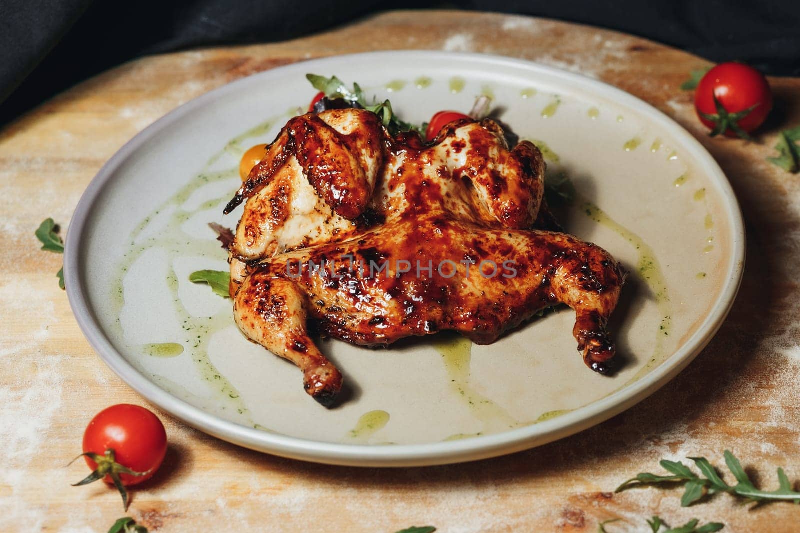 A plate filled with succulent grilled chicken, juicy tomatoes, and fresh herbs, creating a flavorful and appetizing meal.