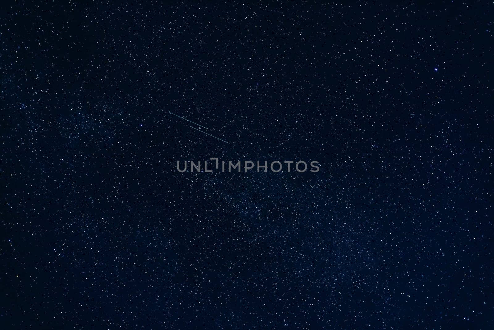 shooting stars in the starry dark blue night sky