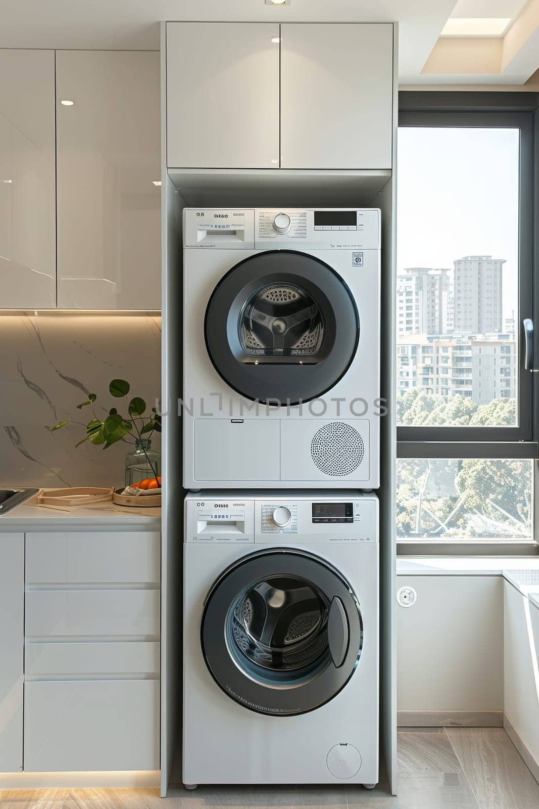 A white washing machine with a black drum sits on top of another washing machine. The two machines are stacked on top of each other