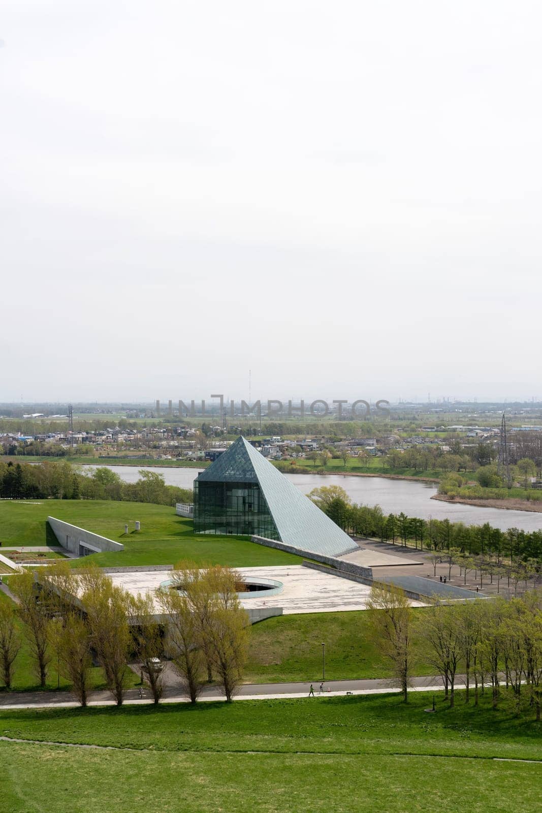 SAPPORO, JAPAN - 05 MAY 2024 : The symbol of Moerenuma park, the glass pyramid Hidamari, on February 5 in Sapporo. The glass pyramid is multi-purpose space, such as cultural activities and museum.