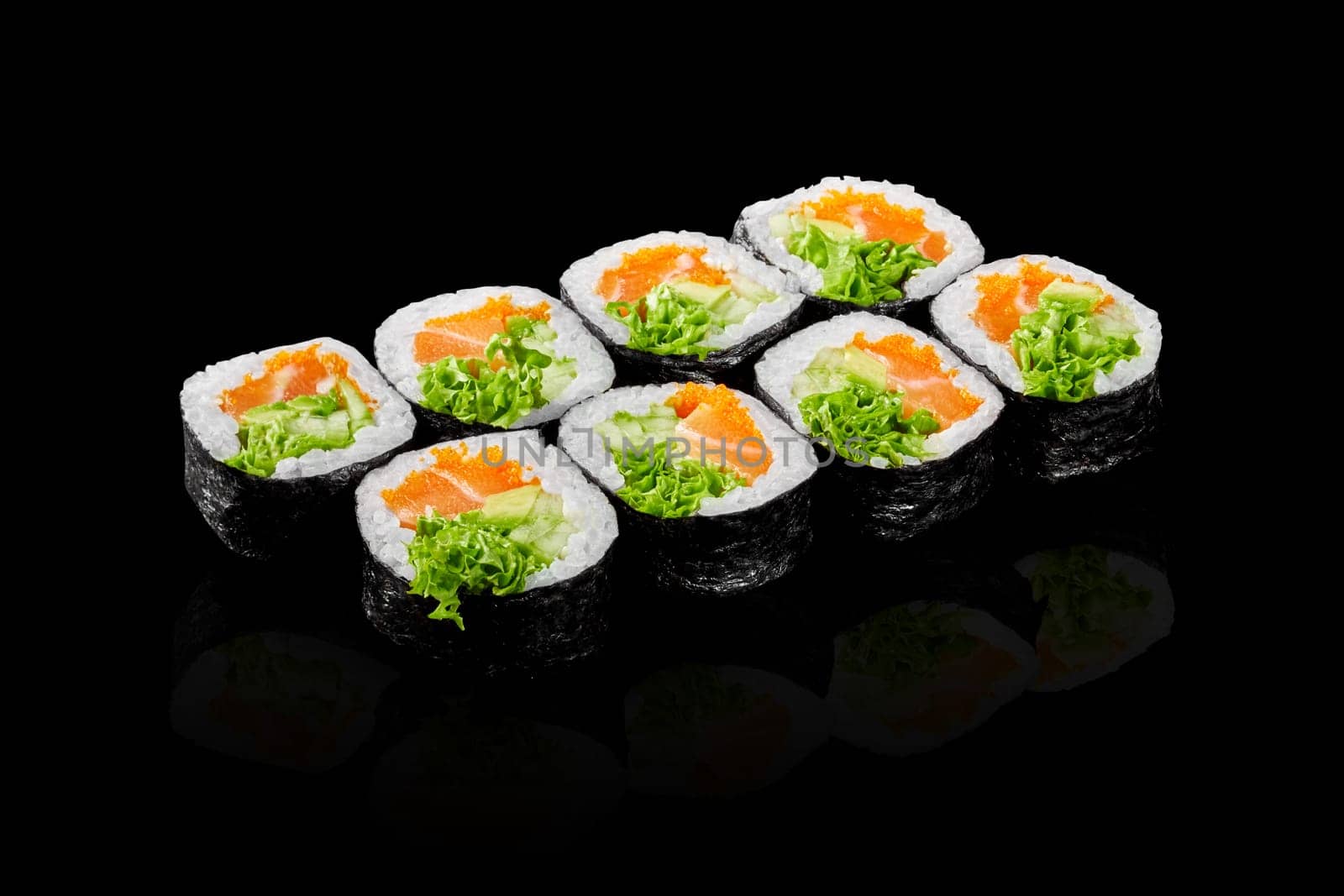 Futomaki rolls with salmon, tobiko and greens on black background by nazarovsergey
